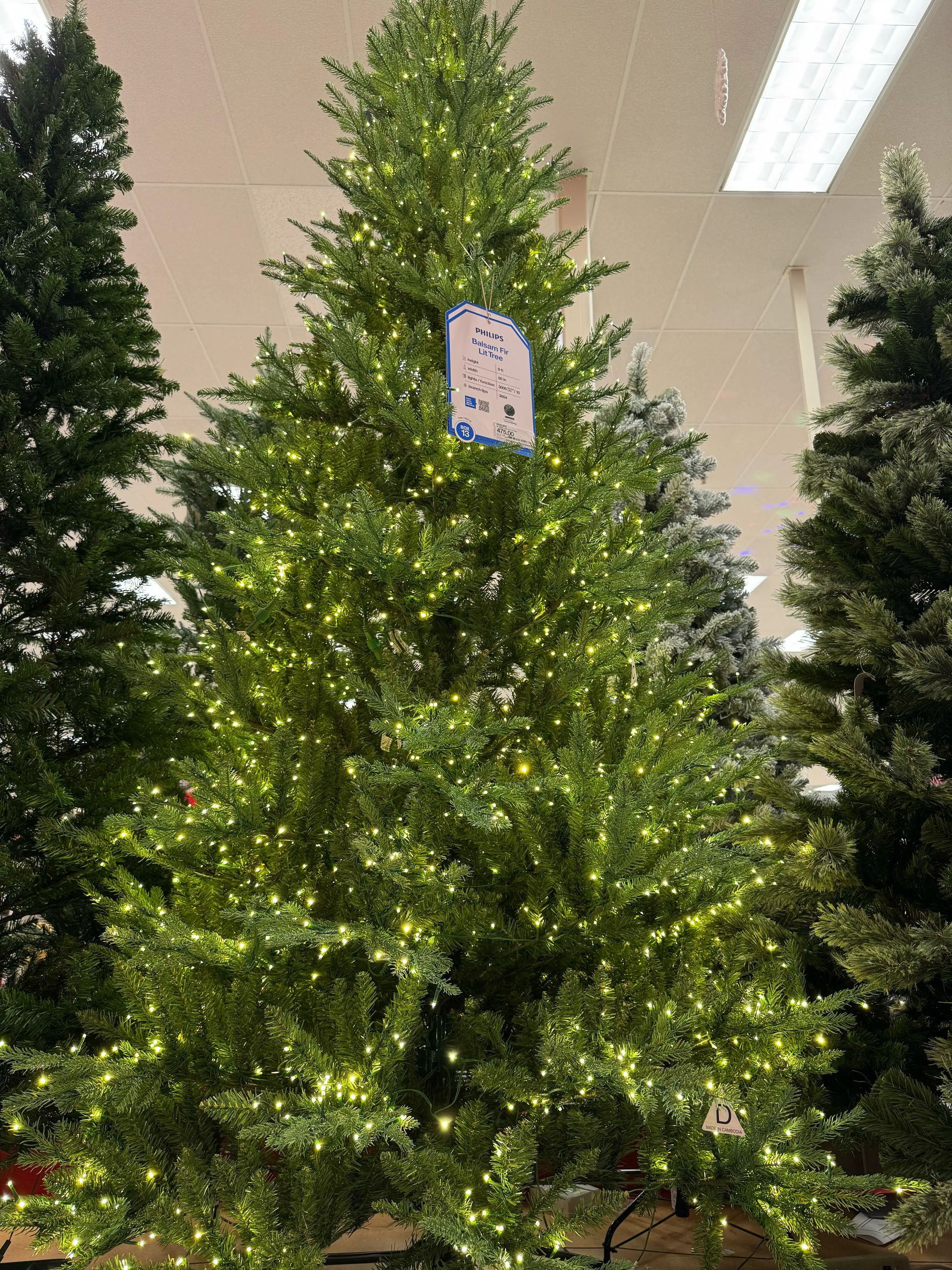 Dense mixed PVC/PE fir with realistic molded tips, full branching with minimal gaps, warm white LED lights evenly distributed