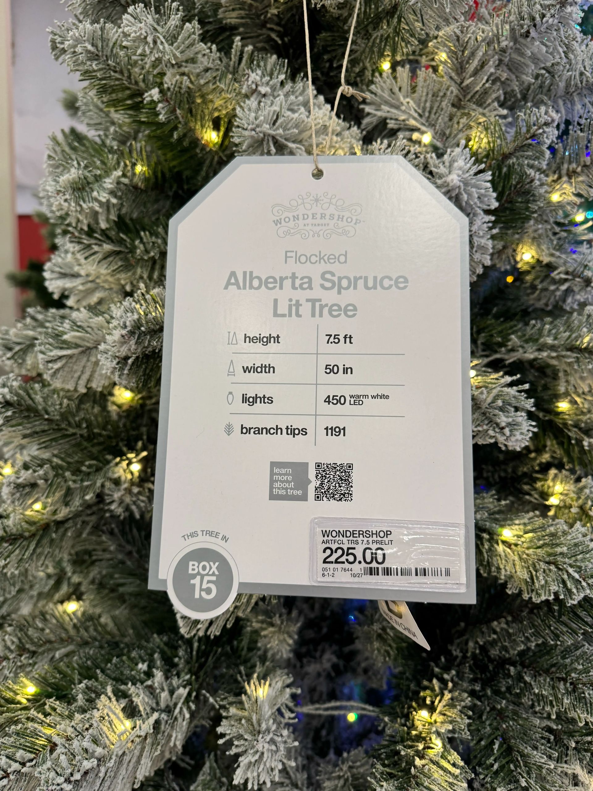 Product tag showing 7.5ft flocked tree specs: 50in wide, 450 warm white LEDs, 1191 branch tips, priced at $225
