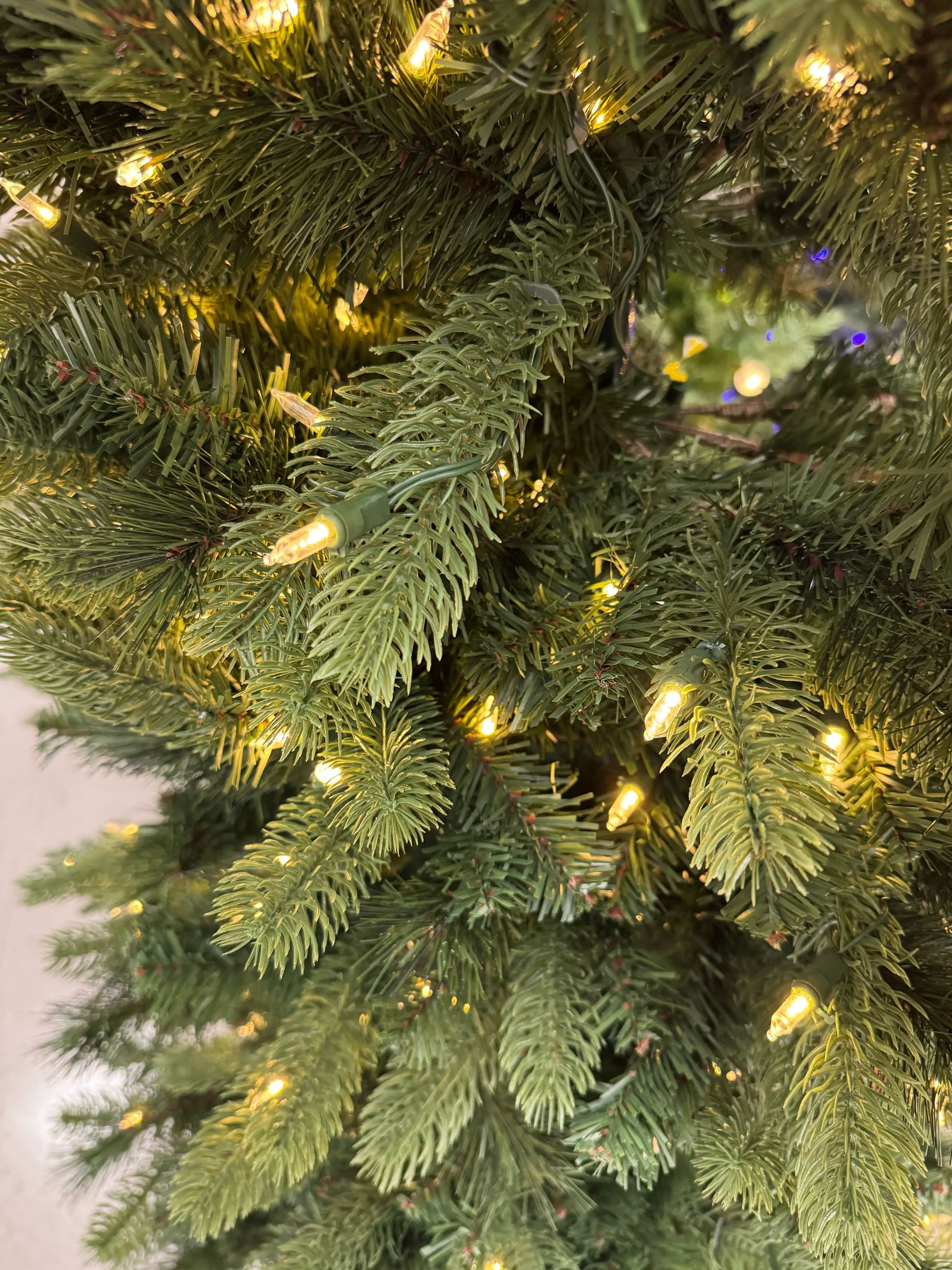Mixed PVC and PE needles with warm white mini bulbs, moderate density, visible wire stems between branches