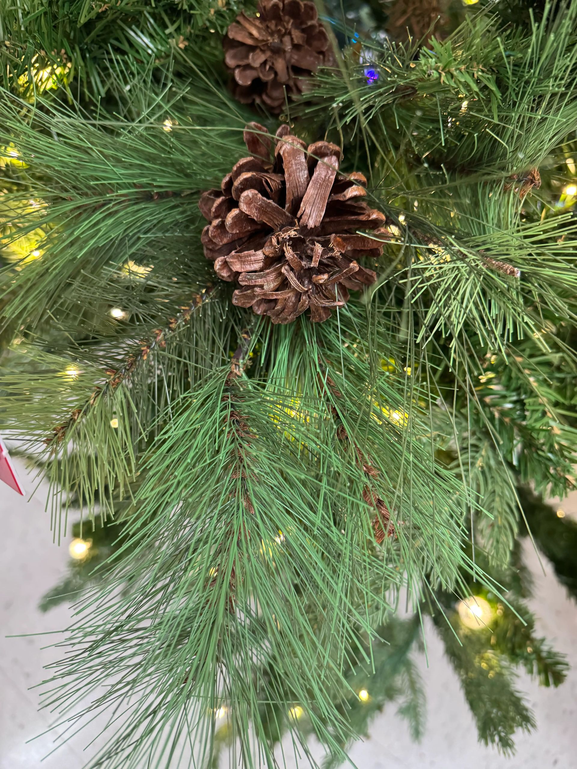 Mixed PVC and molded PE spruce needles with brown pinecones, warm micro LEDs, dense realistic branching