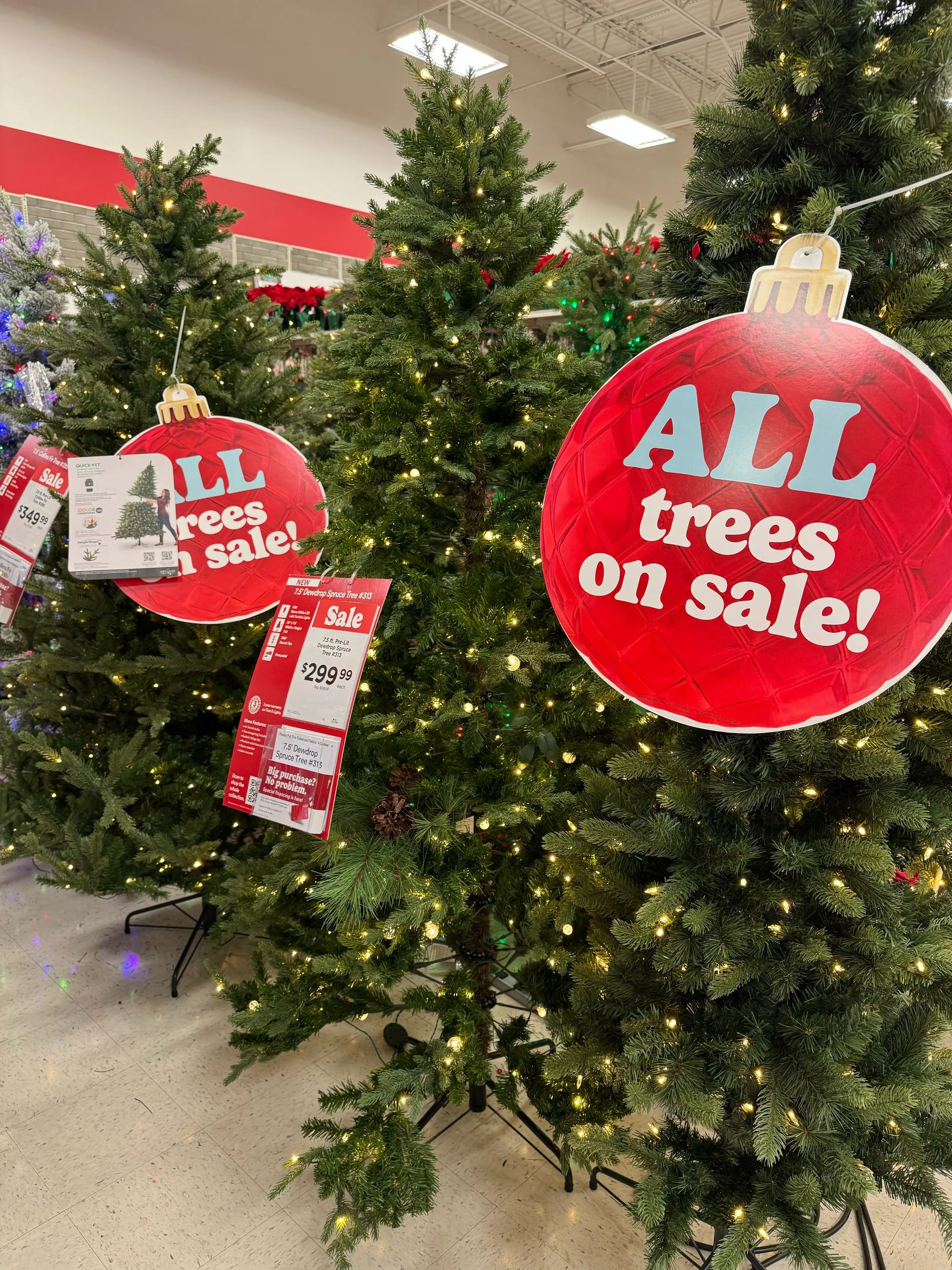 Multiple full spruce-style trees with dense PVC branches, warm white mini bulbs throughout, minimal gaps