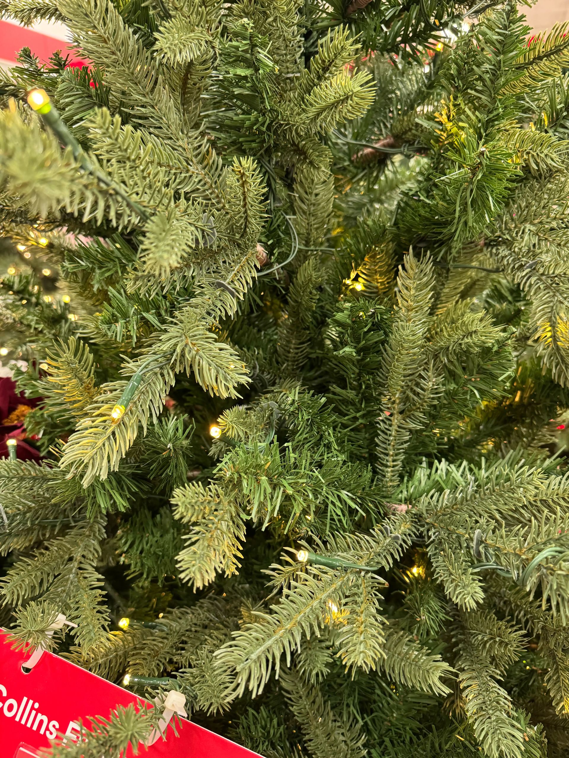 Mixed PVC and molded PE fir needles in natural green tones, warm white micro LEDs scattered throughout branches