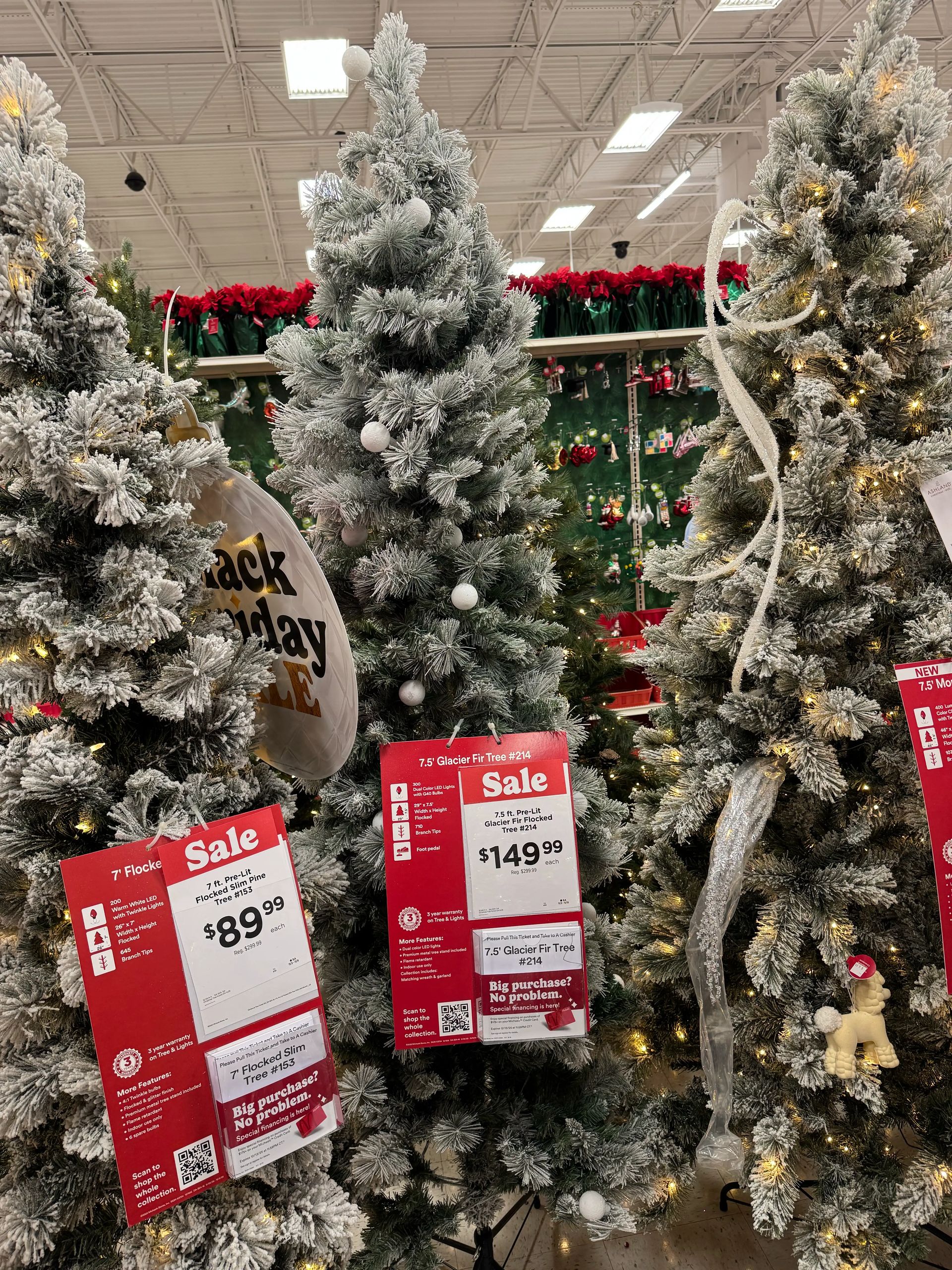 Slim fir-style tree with mixed PVC tips, heavy white flocking, warm white lights, moderate branching with some gaps