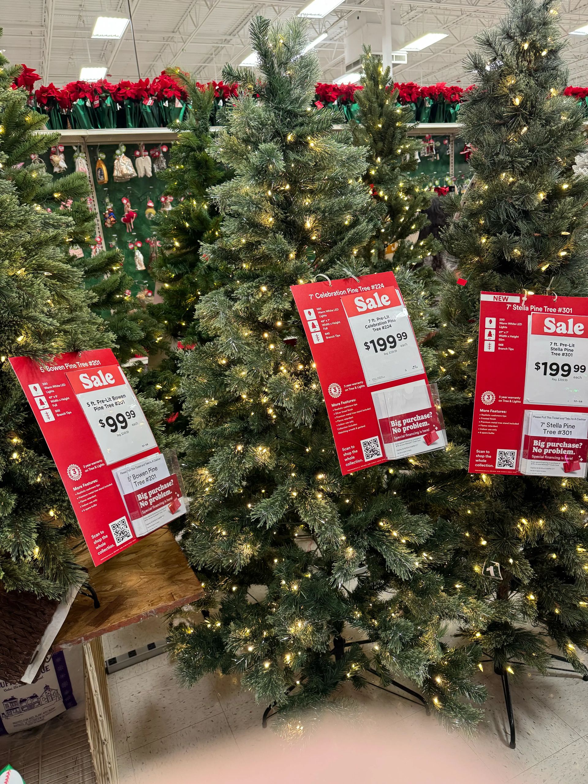 Dense pine-style tree with PVC needles and silver tinsel strands, warm white mini bulbs throughout, full shape