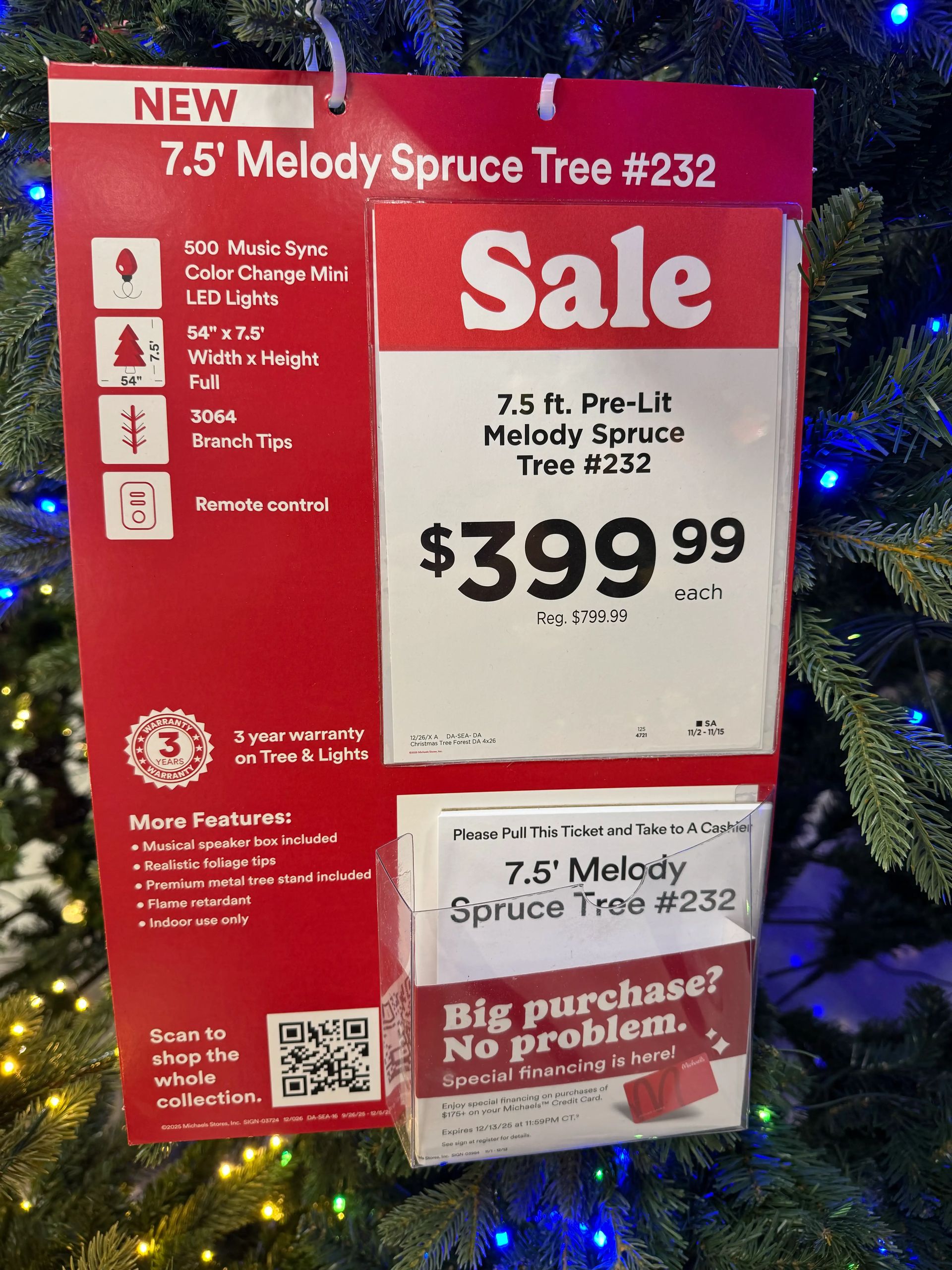 Sale sign showing 7.5ft pre-lit tree specs: 500 music sync color-change LEDs, 3064 tips, remote control, $399.99