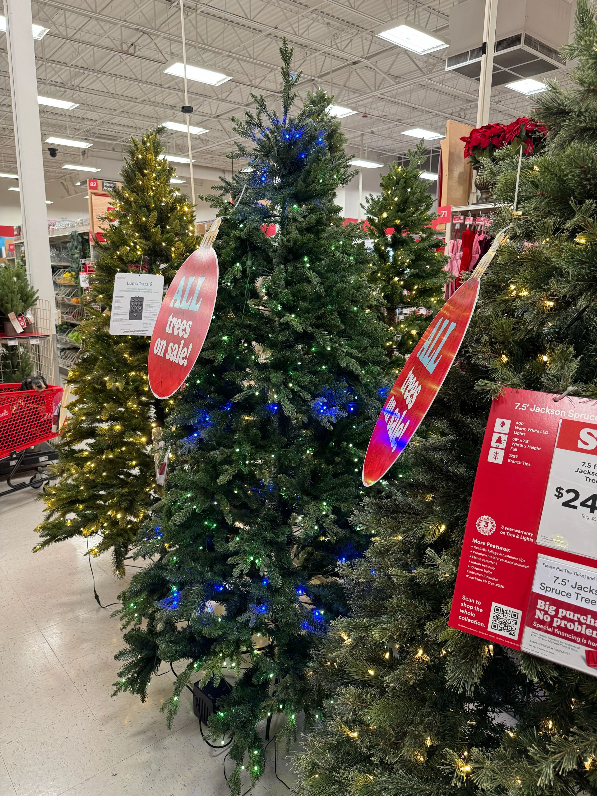 Full spruce-style tree with dense PVC branches, blue and warm white mini bulbs throughout, minimal gaps visible