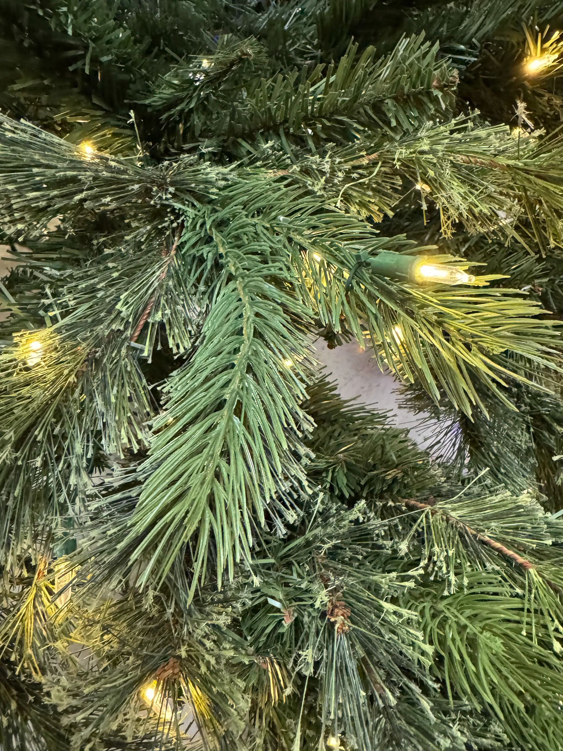 Dense mixed PVC/PE spruce needles with warm white micro LEDs, moderate light spacing, full branching visible