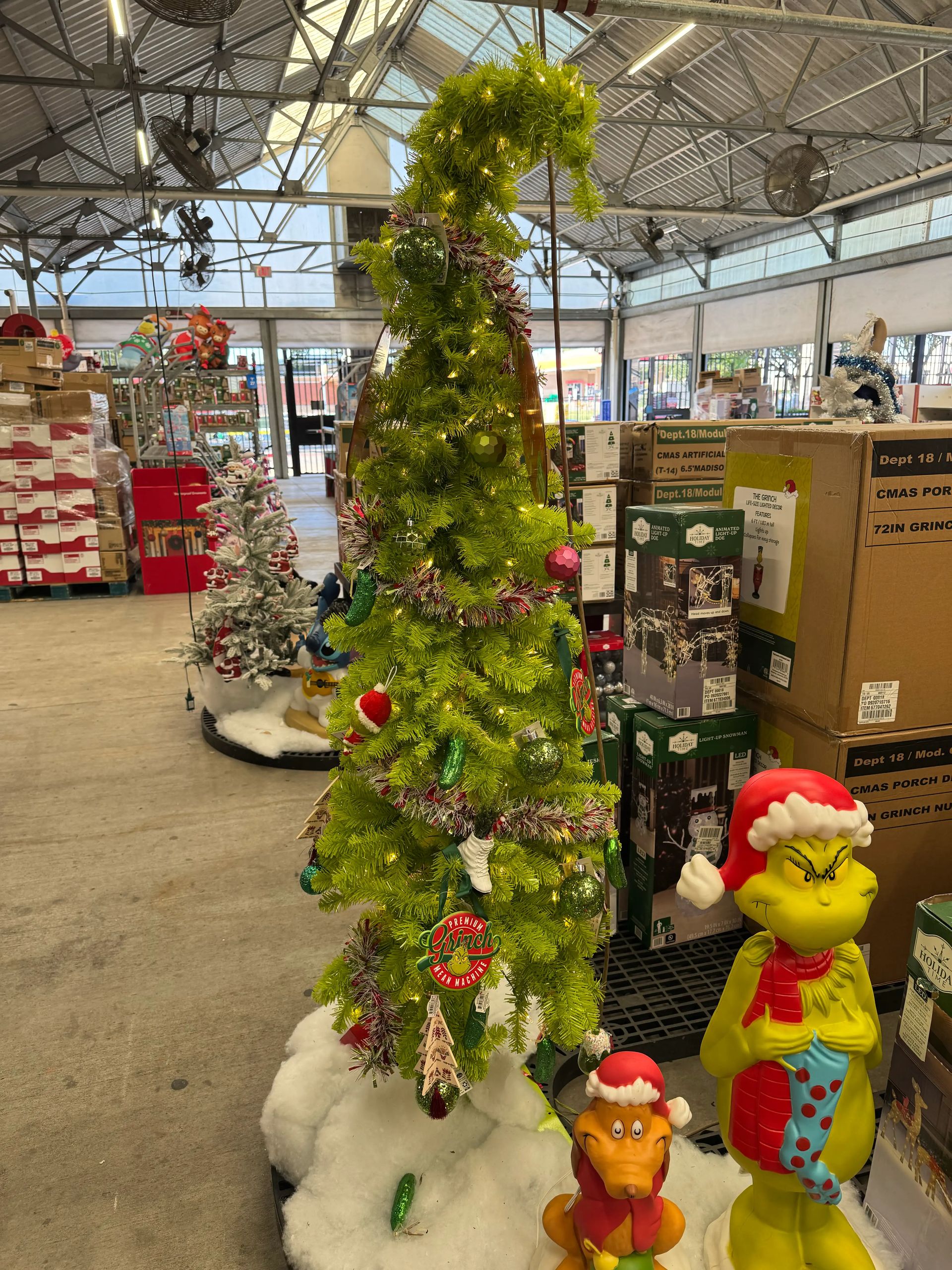 Whimsical curved spruce-style tree in bright lime green, moderate PVC branching, warm white lights, decorated with ornaments