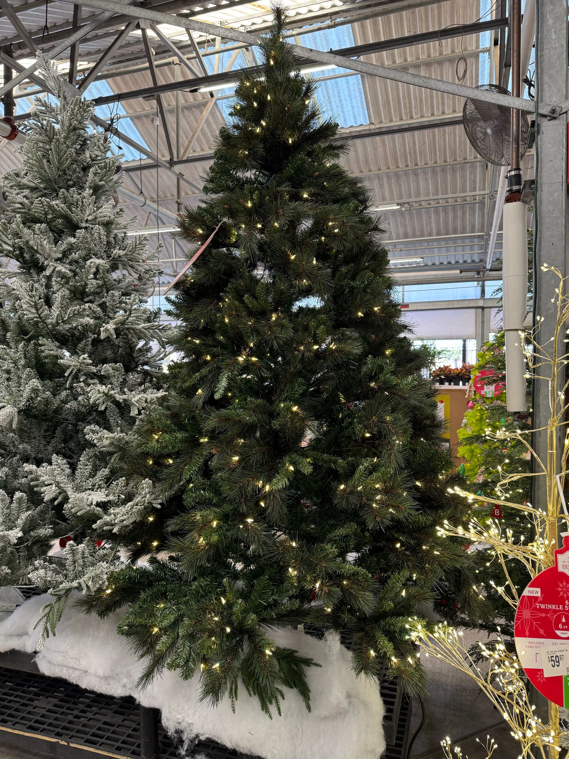 Full traditional pine-style tree with dense PVC needles, warm white lights evenly distributed, minimal visible gaps