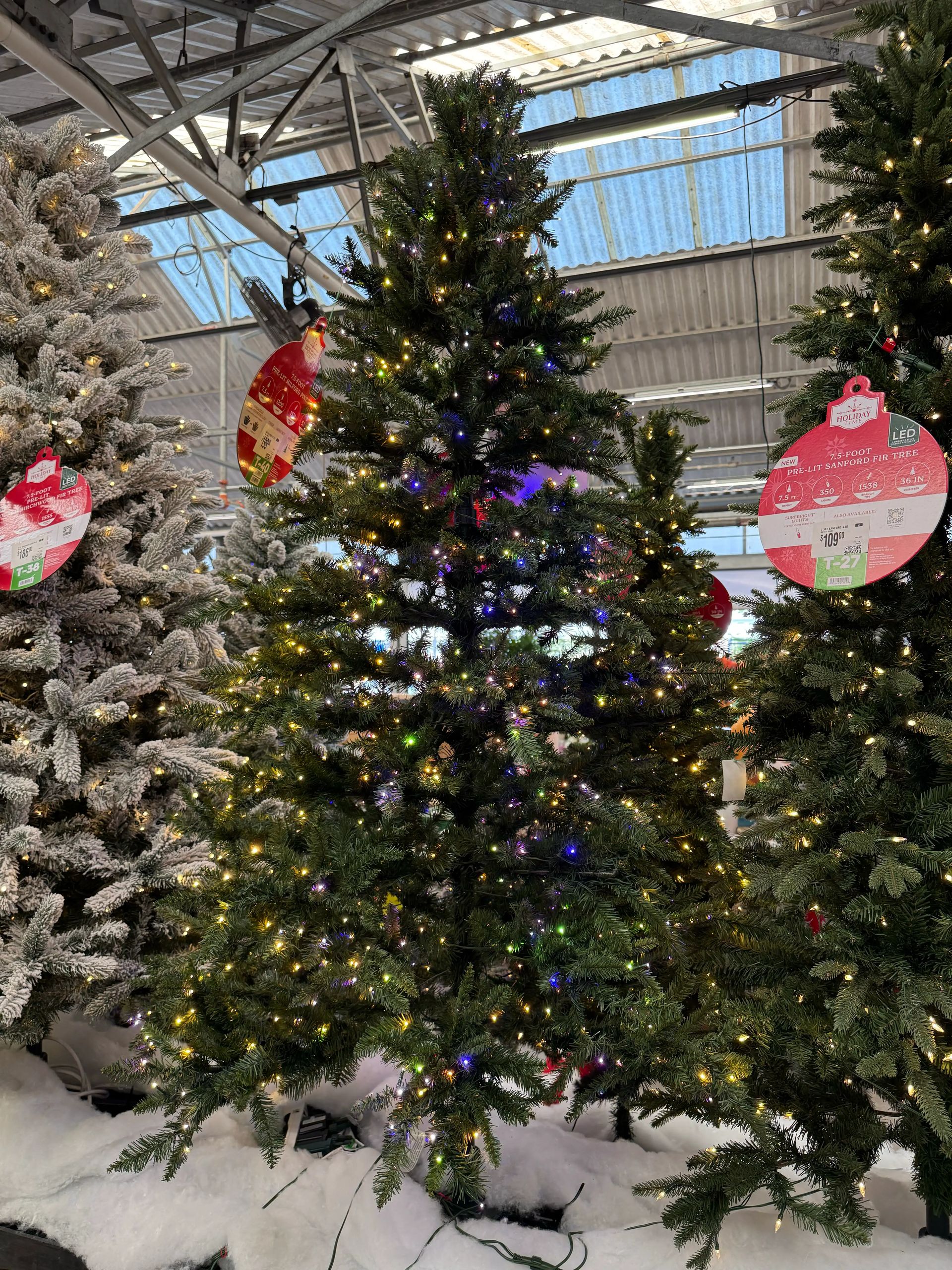 Dense traditional PVC pine tree with multicolor LED lights throughout, full branching with minimal gaps, natural green