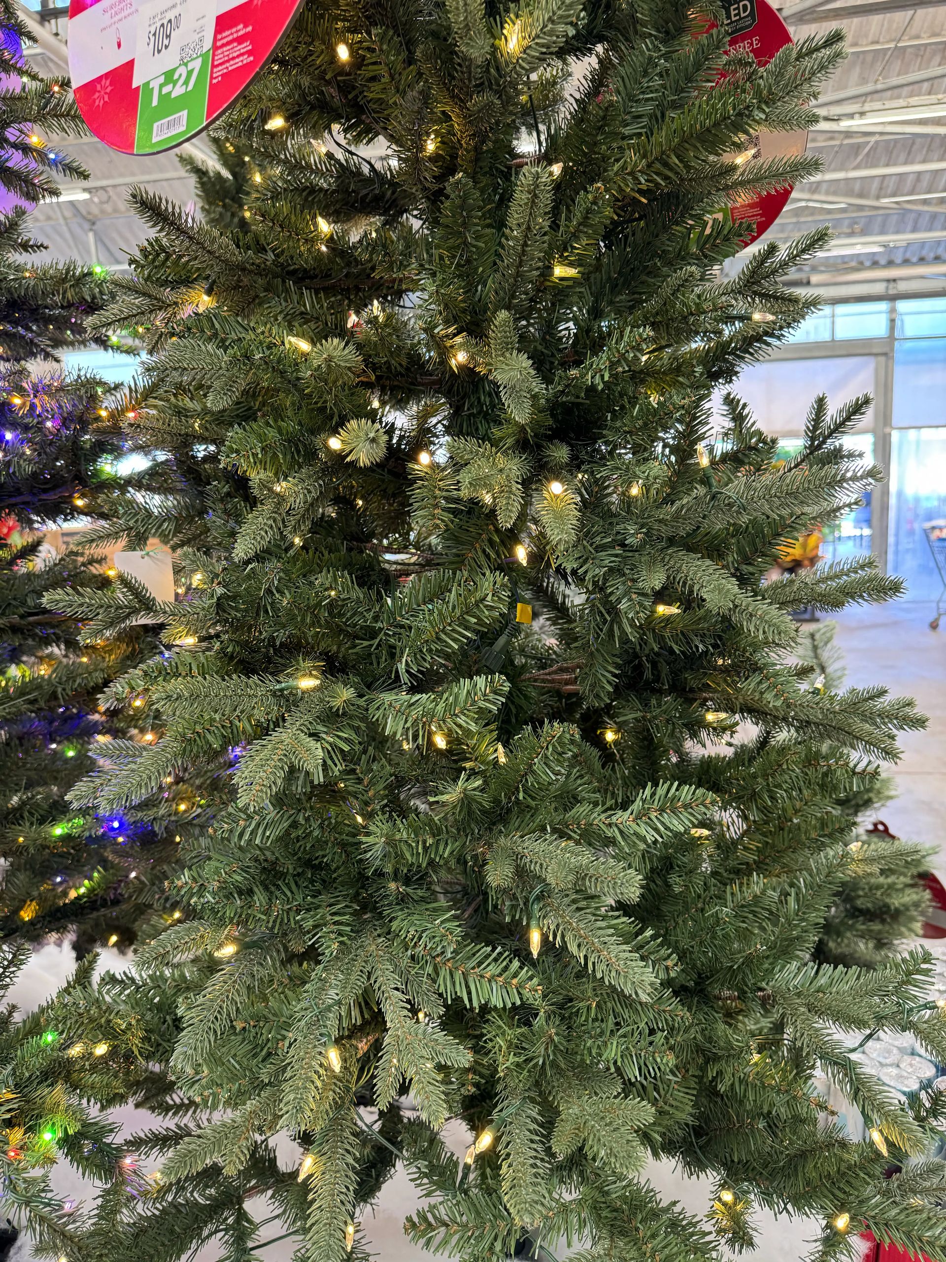 Dense mixed PVC/PE fir with full branching, minimal gaps, warm white LED lights evenly distributed throughout