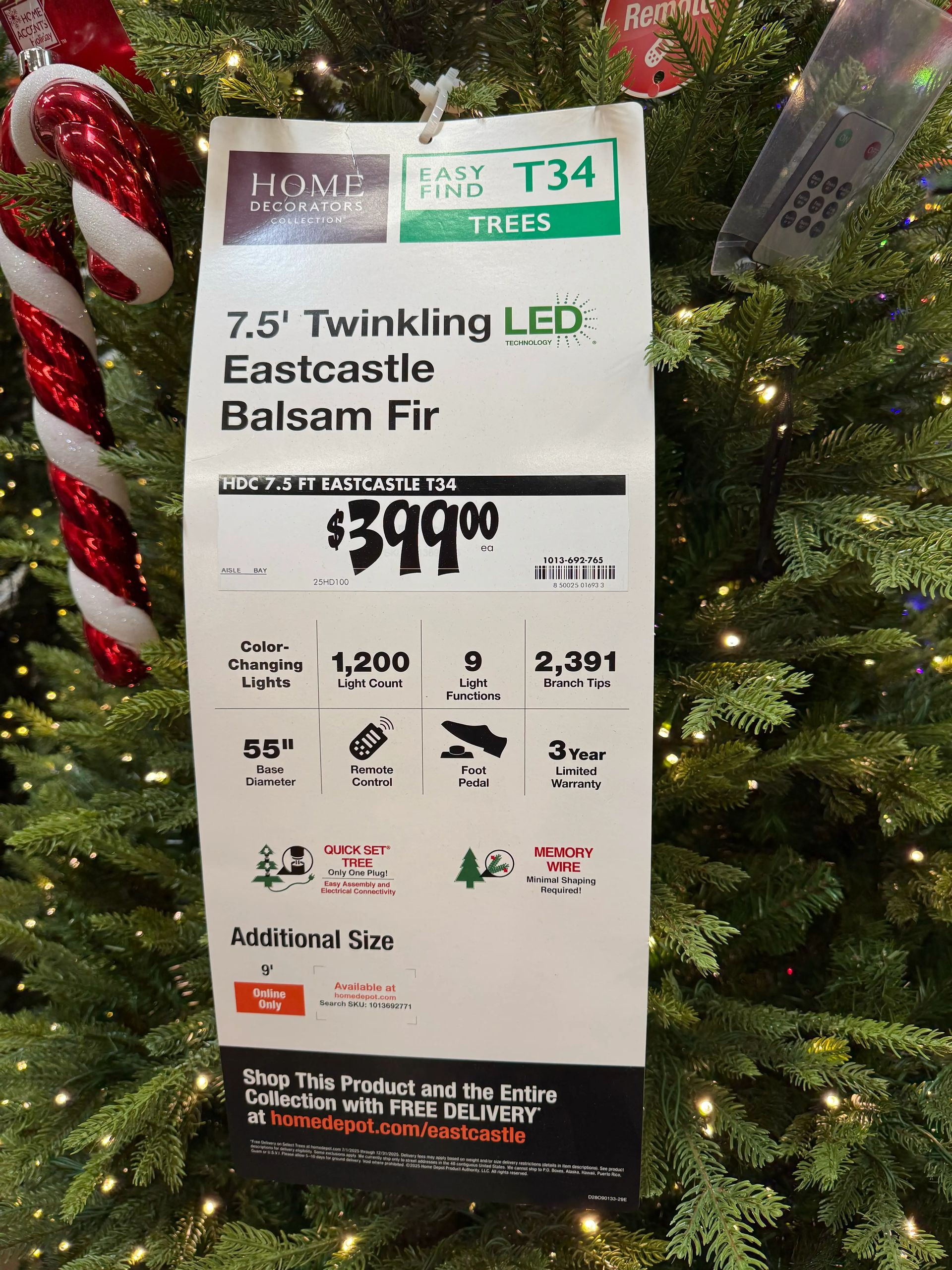 Product tag showing 7.5ft tree specs: 1,200 lights, 9 functions, 2,391 tips, remote control, foot pedal, $399