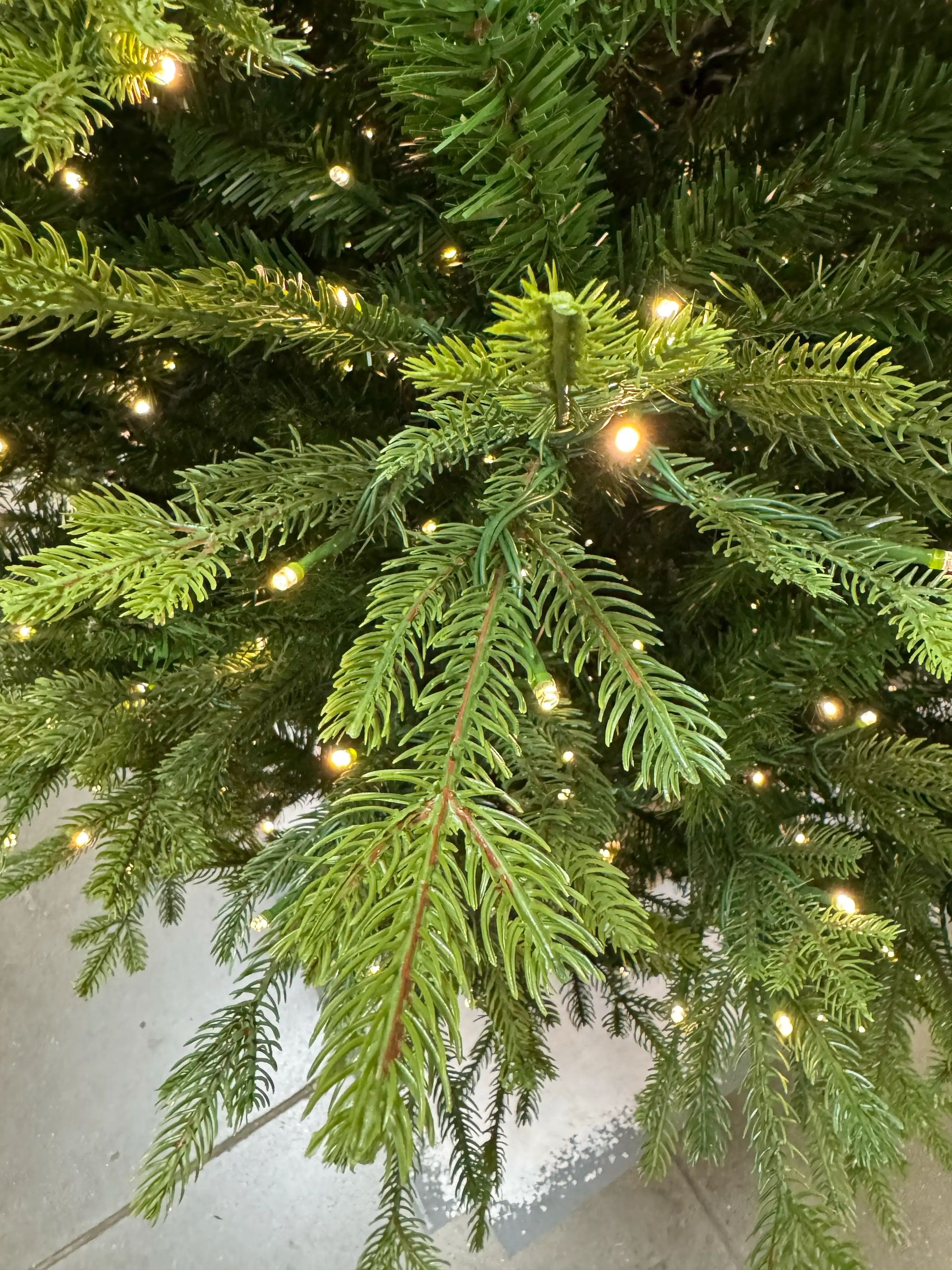 Mixed PVC and molded PE fir needles, bright lime-green tips, warm white micro LEDs throughout branches