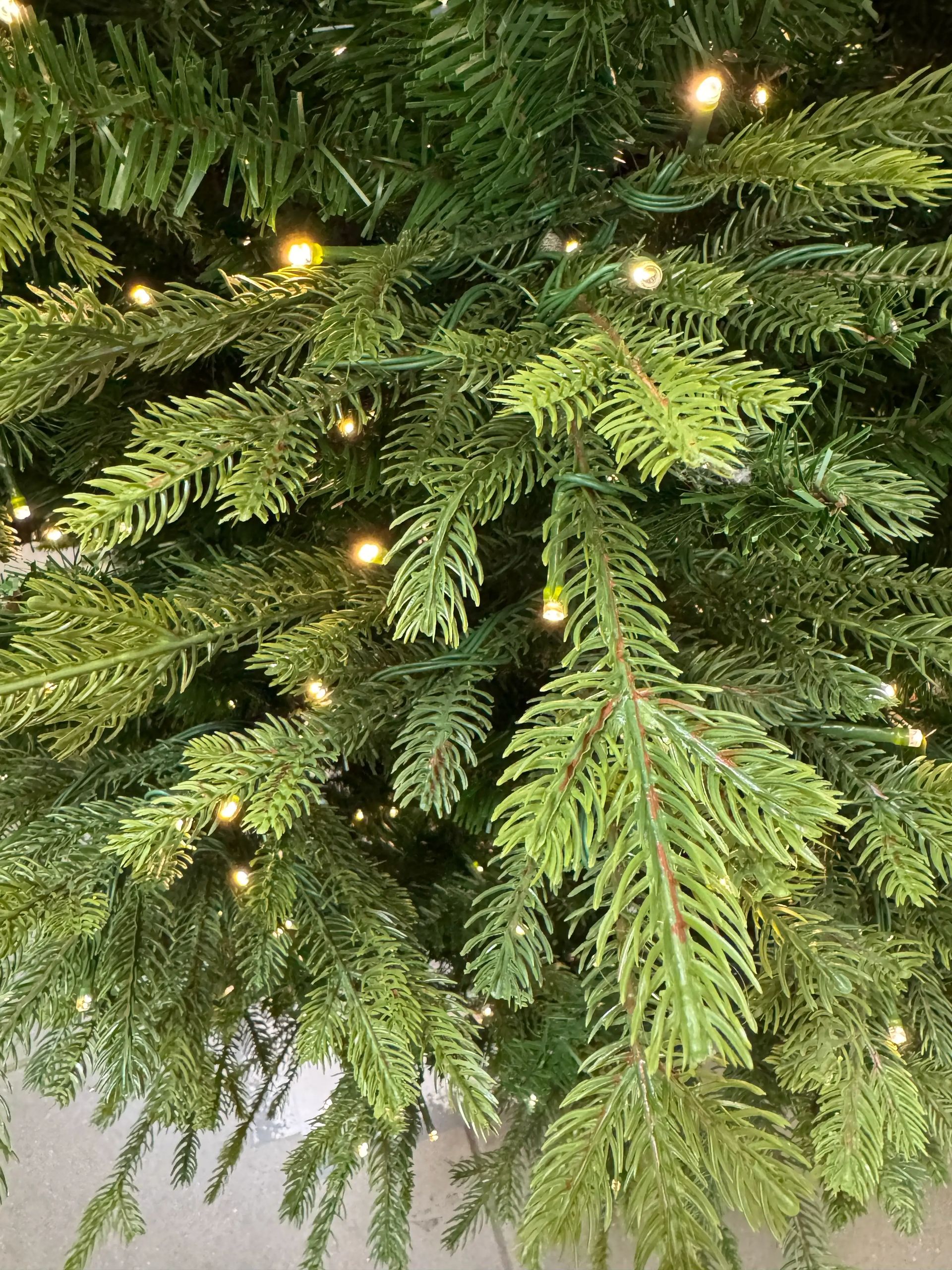 Dense mixed PVC/PE fir needles in realistic green shades, warm white micro LEDs evenly spaced throughout branches