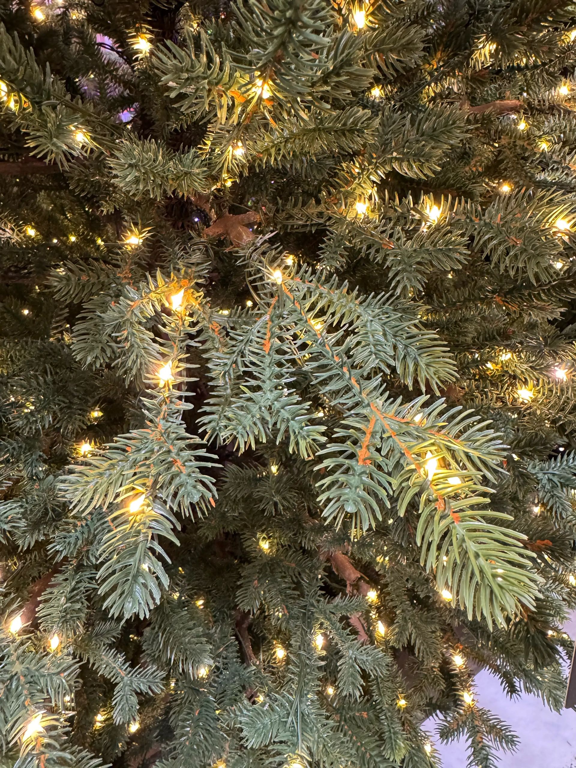Dense molded PE fir needles with warm white micro LED lights evenly distributed throughout, realistic texture visible