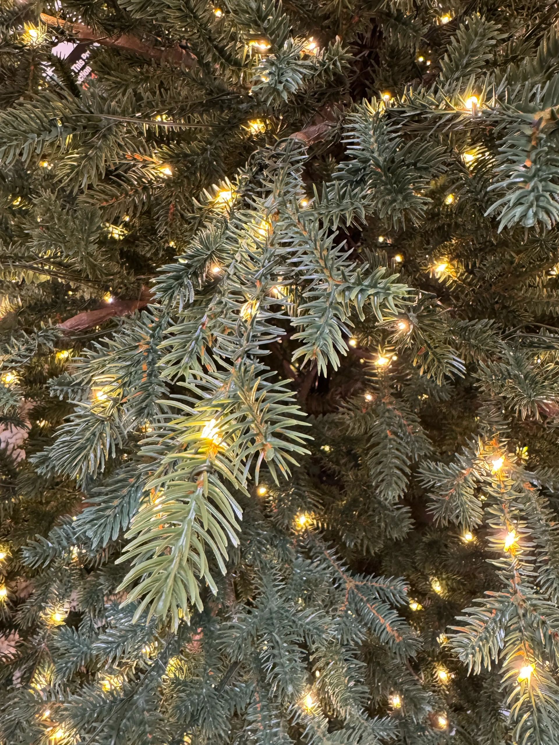 Dense molded PE fir needles in gray-green tones, warm white micro LEDs throughout, realistic texture with no visible gaps