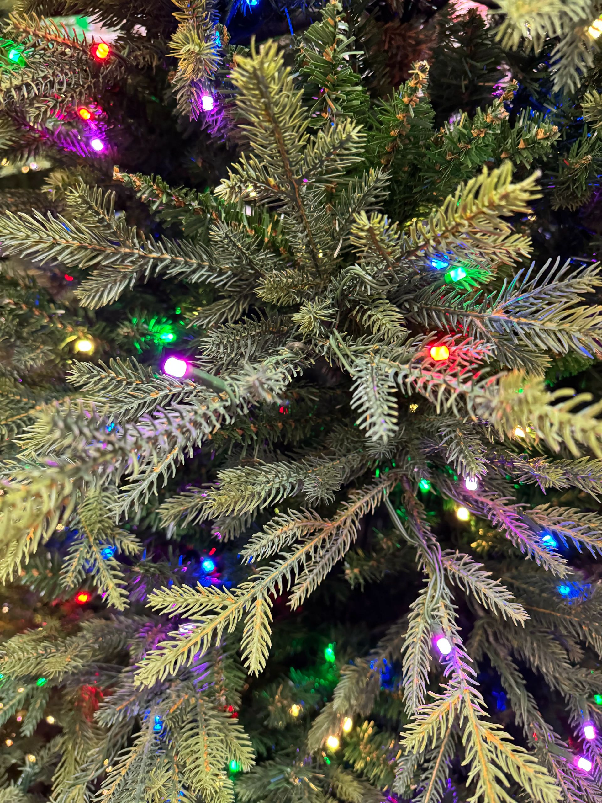 Mixed PVC and PE fir needles with dense multicolor LED coverage, realistic molded tips visible throughout branches