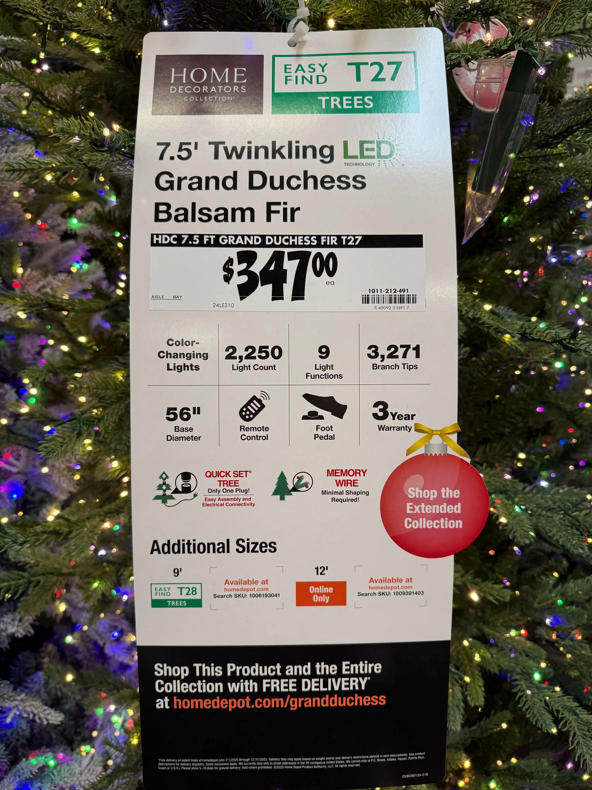 Product sign: 7.5ft Grand Duchess Fir, $347, 2,250 color-changing lights, 9 functions, 3,271 tips, remote, 3yr warranty