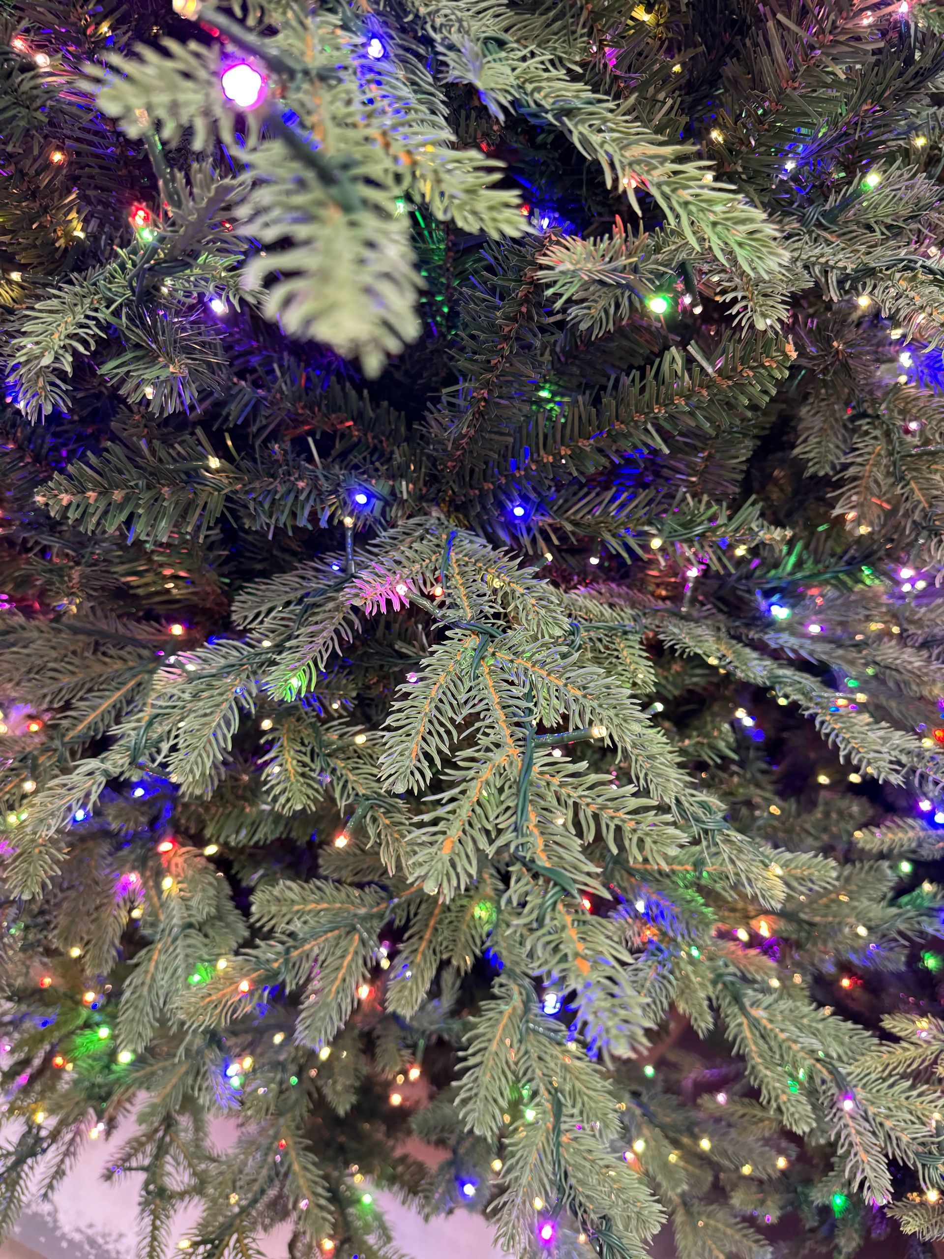 Dense mixed PVC/PE fir needles with multicolor micro LEDs throughout, full branching with no visible gaps