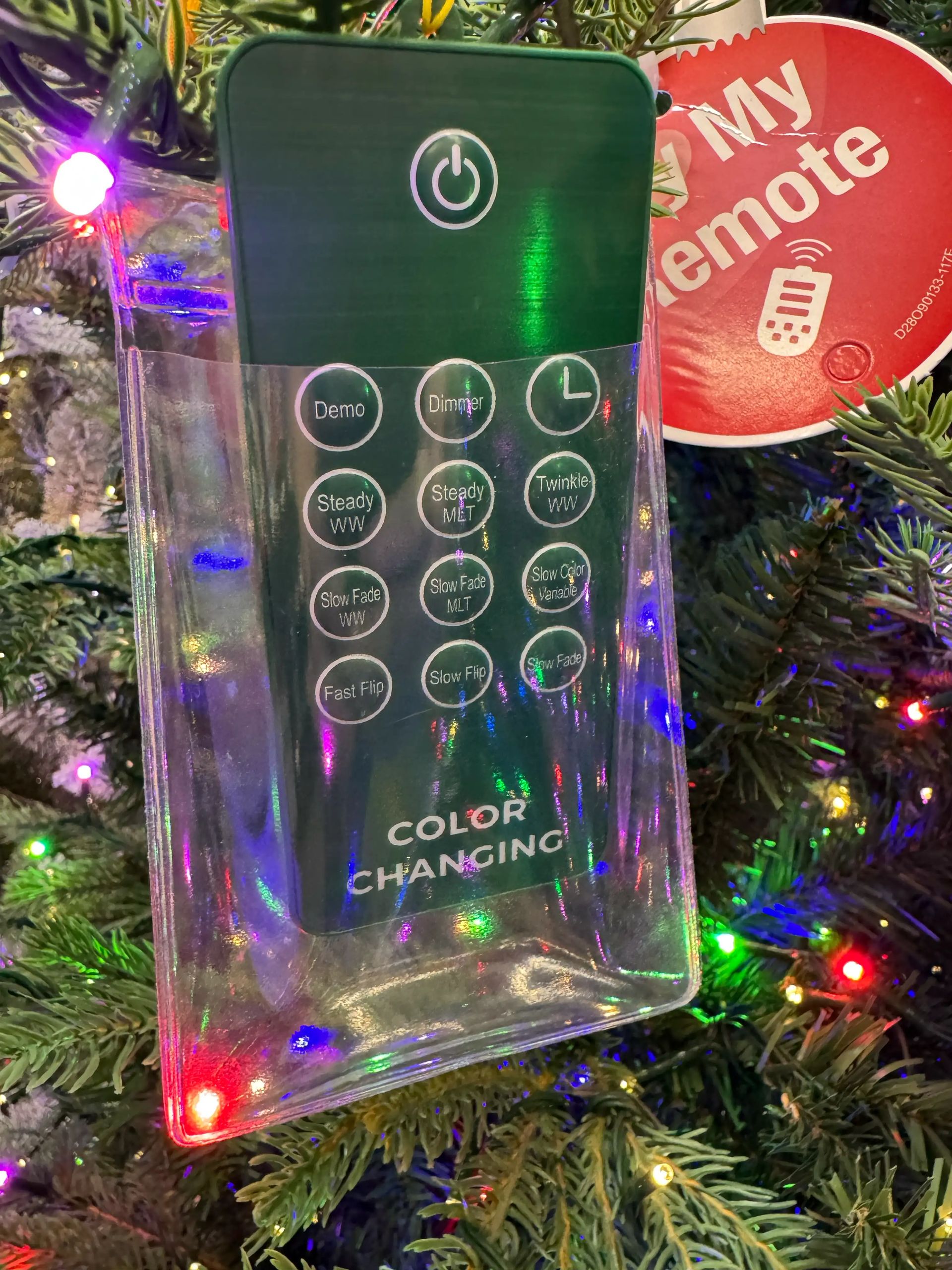 Green remote control for color-changing lights showing power, timer, dimmer, and 9 function buttons including twinkle modes