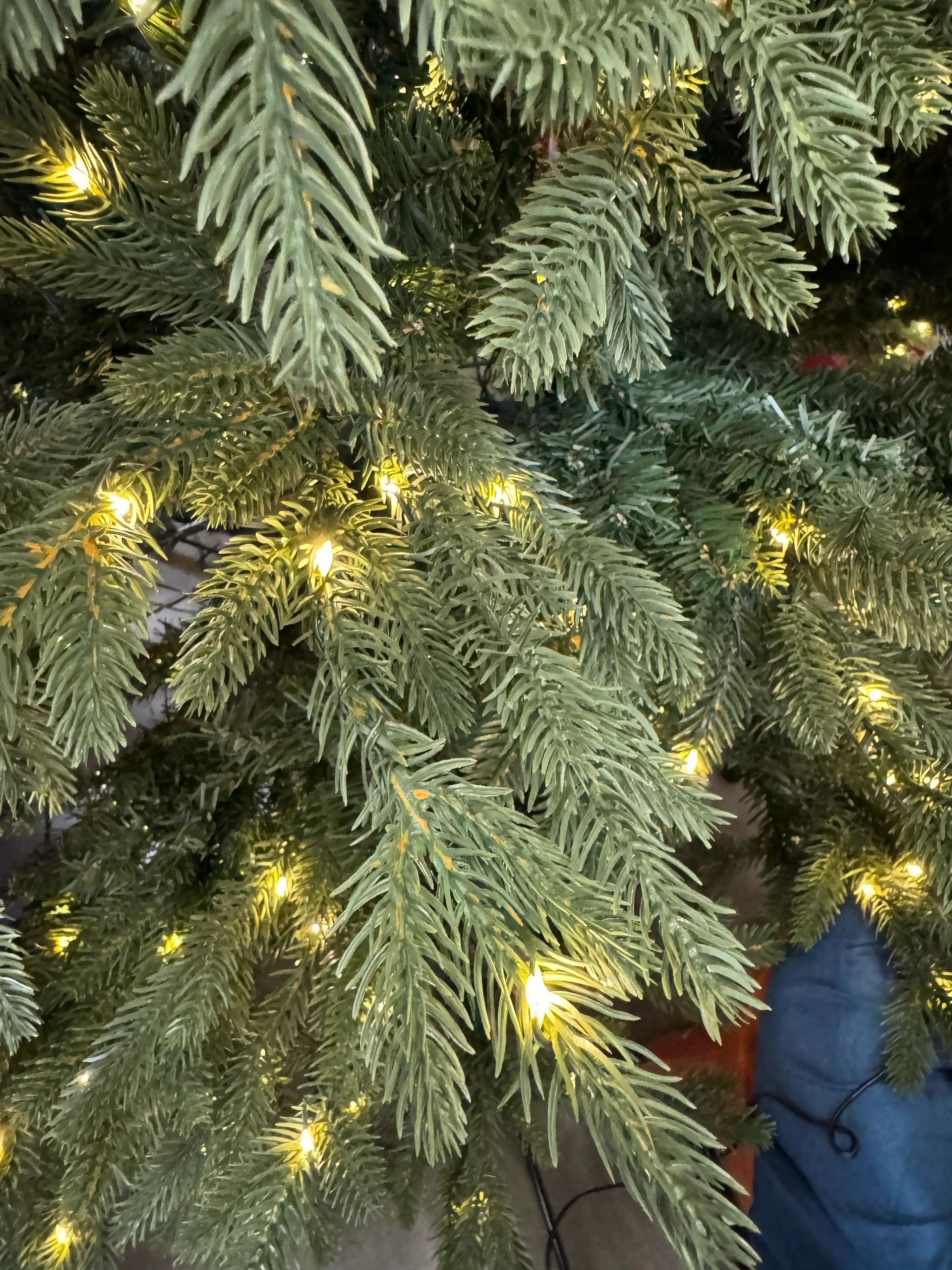Mixed PVC and molded PE fir needles in sage green, warm white micro LEDs throughout, moderate to dense branching