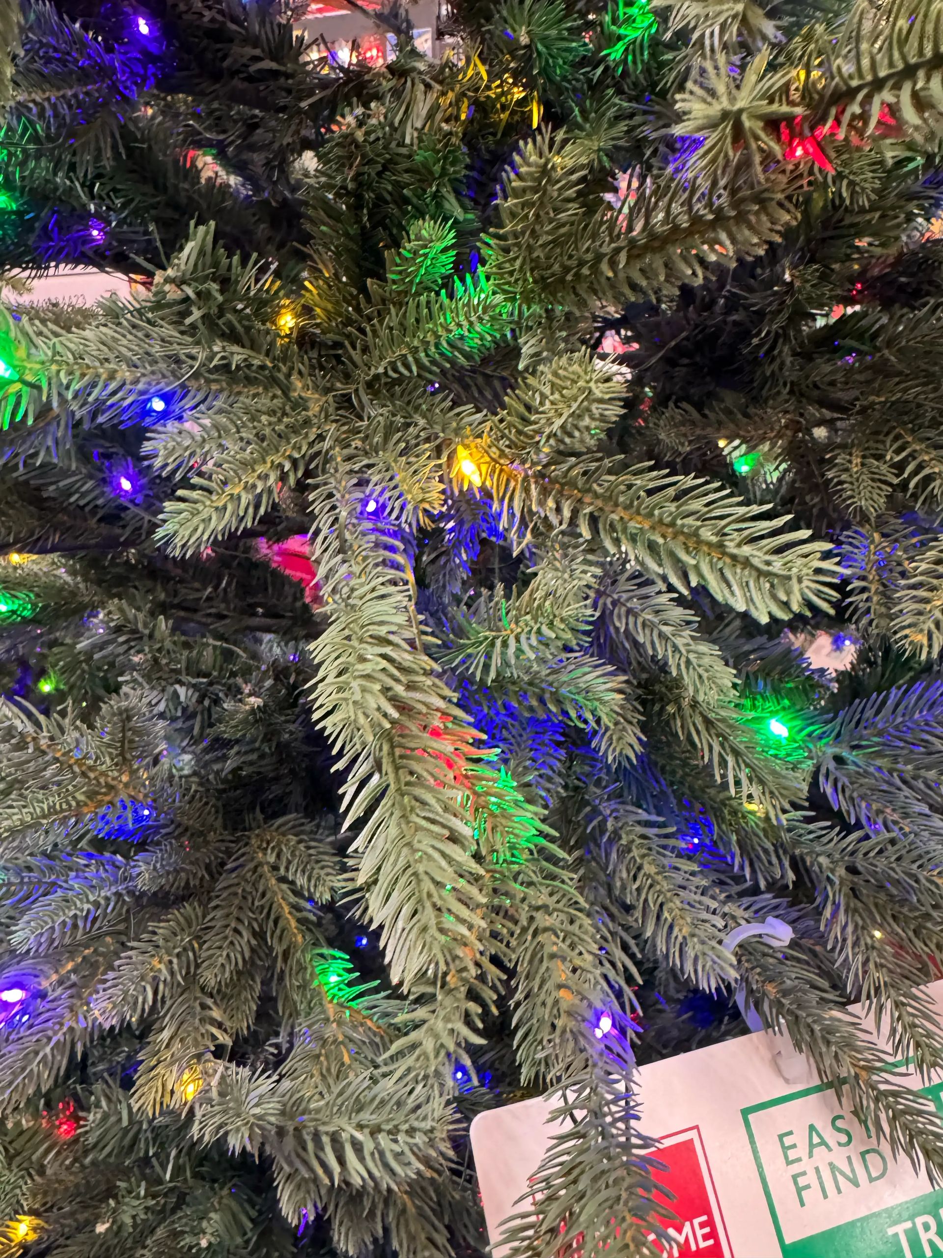 Mixed PVC and molded PE needles, multicolor mini bulbs throughout, moderate light spacing, some visible gaps
