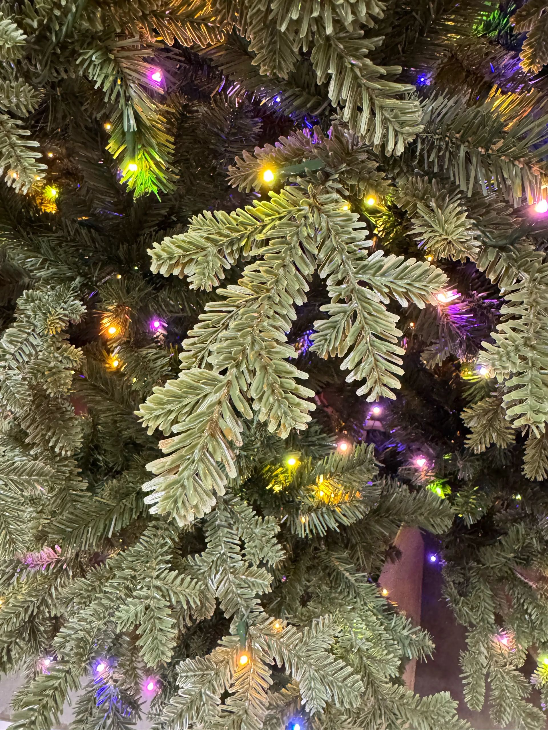 Mixed PVC and PE fir needles with multicolor micro LEDs, moderate density, visible dark branch centers between tips