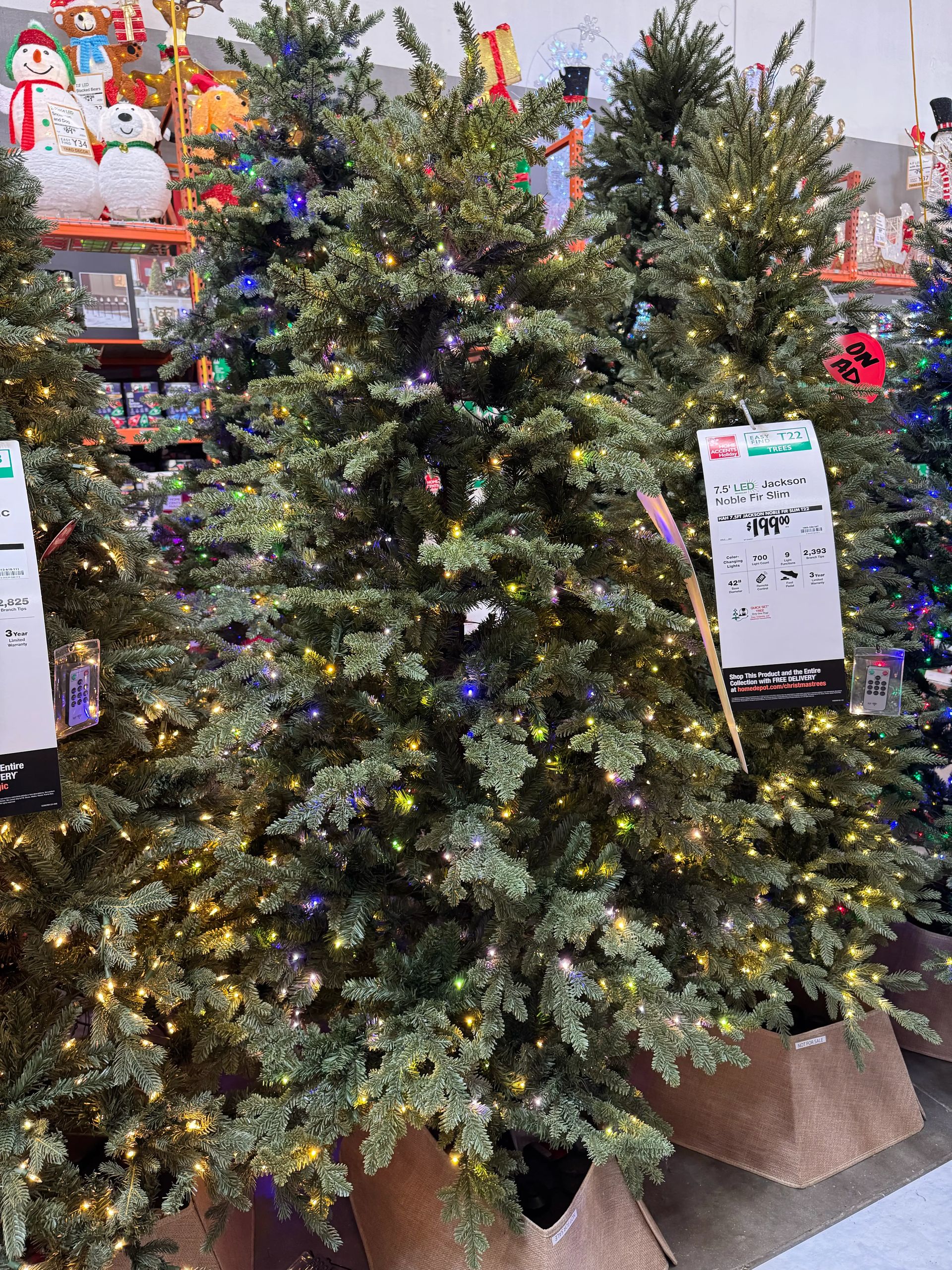 Mixed PVC/PE fir-style tree with moderate fullness, warm white and multicolor LED lights, some visible gaps in branches