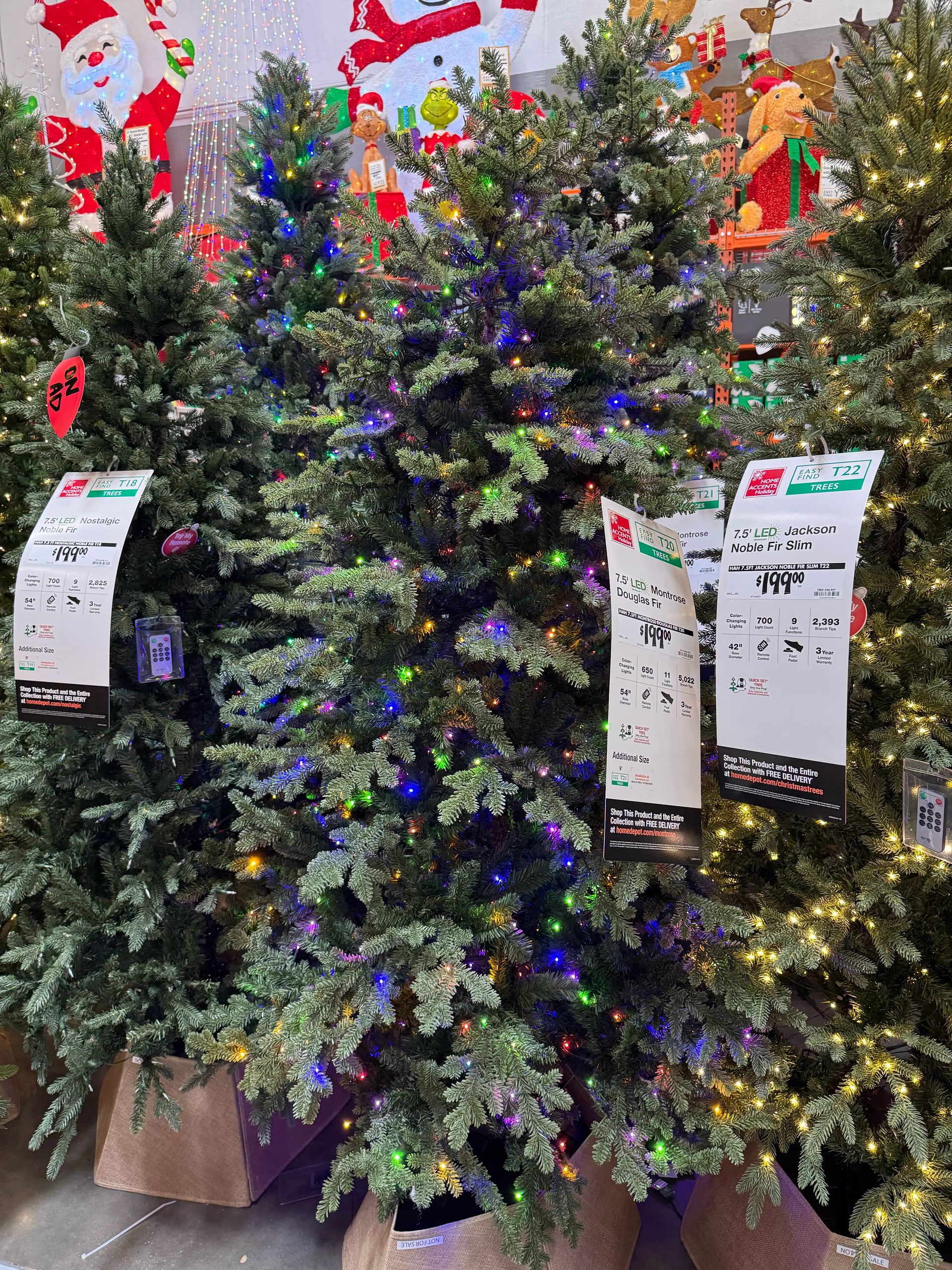 Mixed PVC/PE fir with moderate branching, multicolor LED lights throughout, some visible gaps in coverage