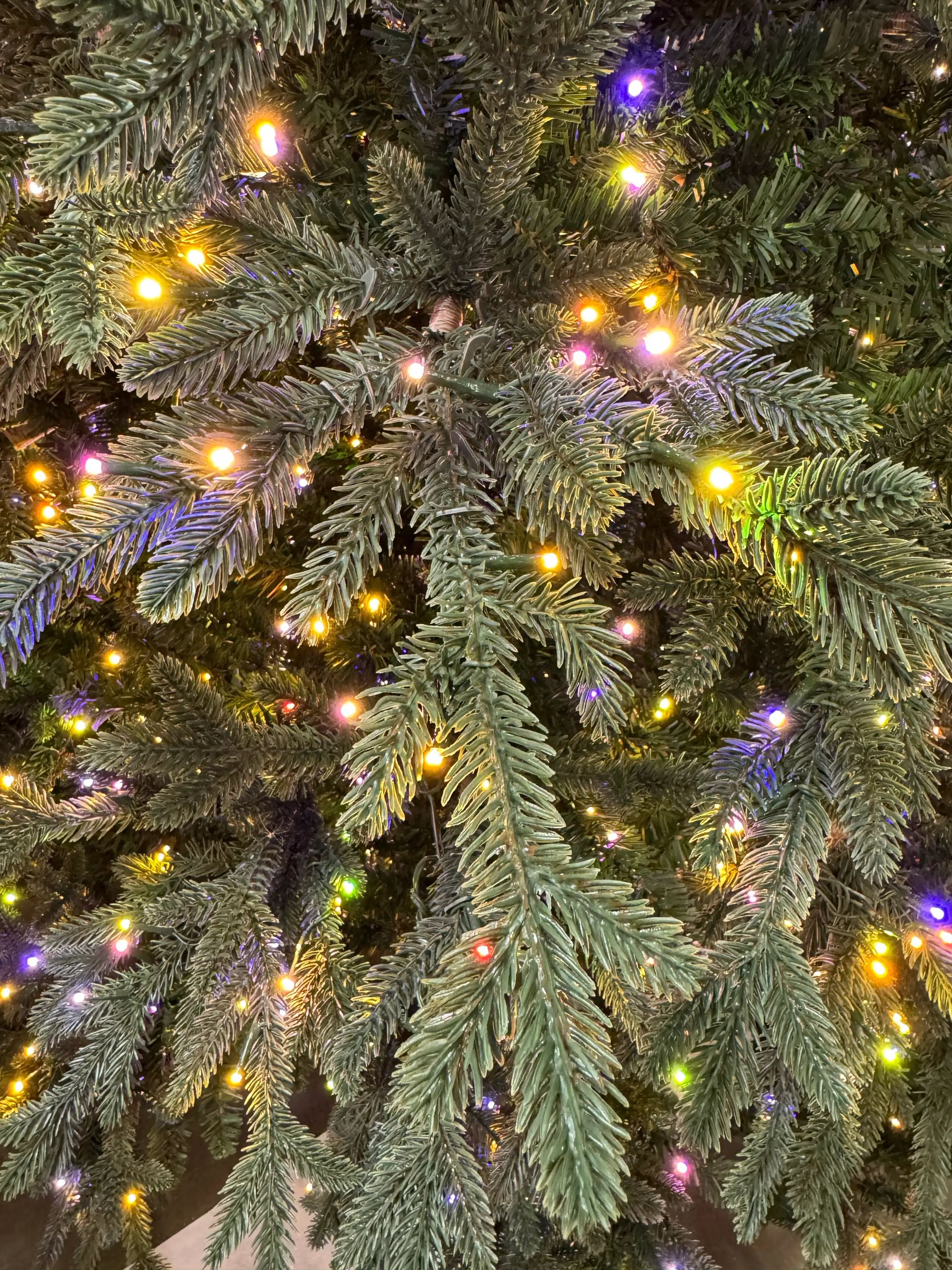 Dense mixed PVC/PE fir needles in deep green, warm white and multicolor micro LEDs distributed throughout branches