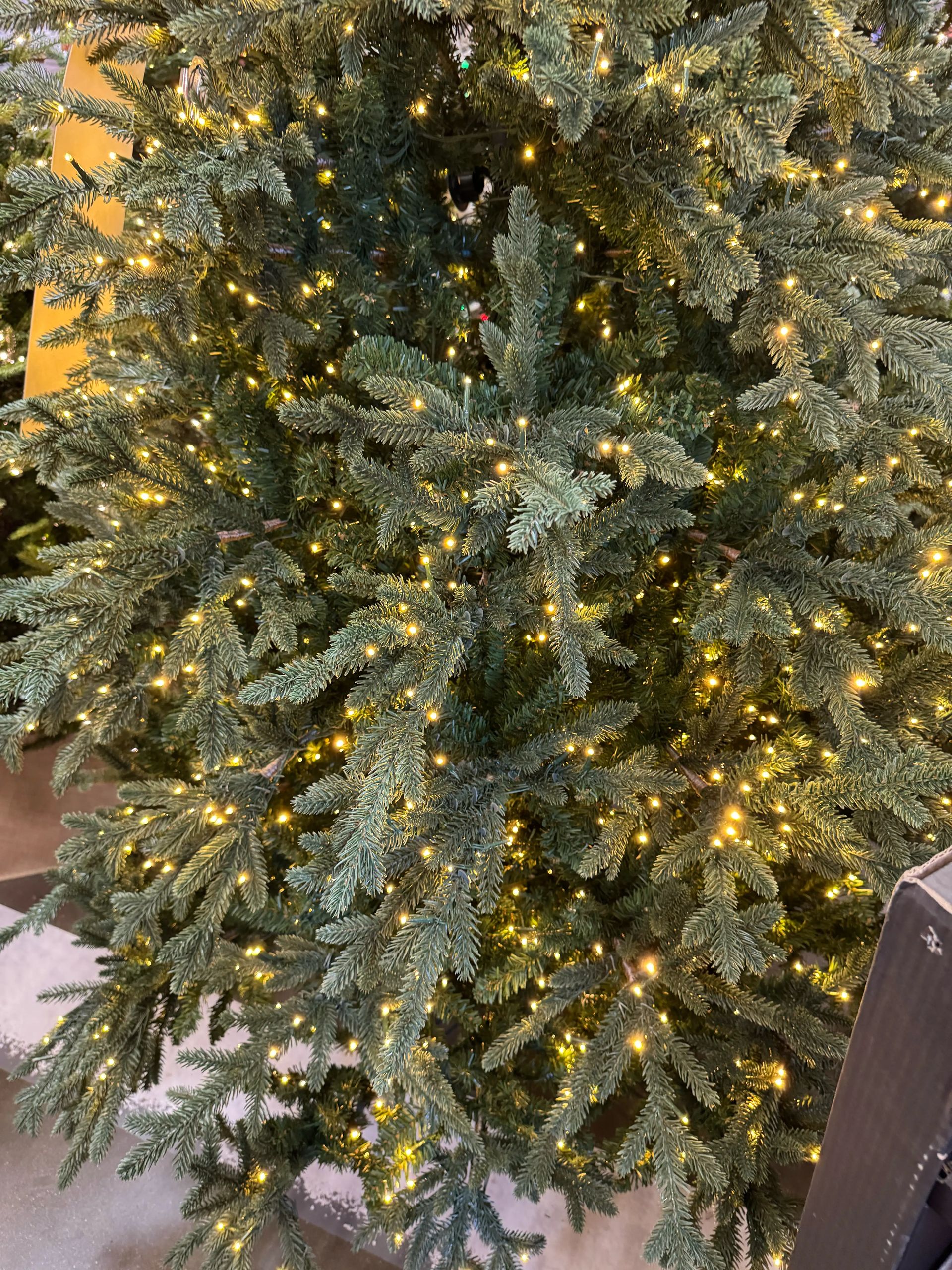 Dense mixed PVC/PE fir needles in sage green, warm white micro LEDs throughout, full coverage with no visible gaps