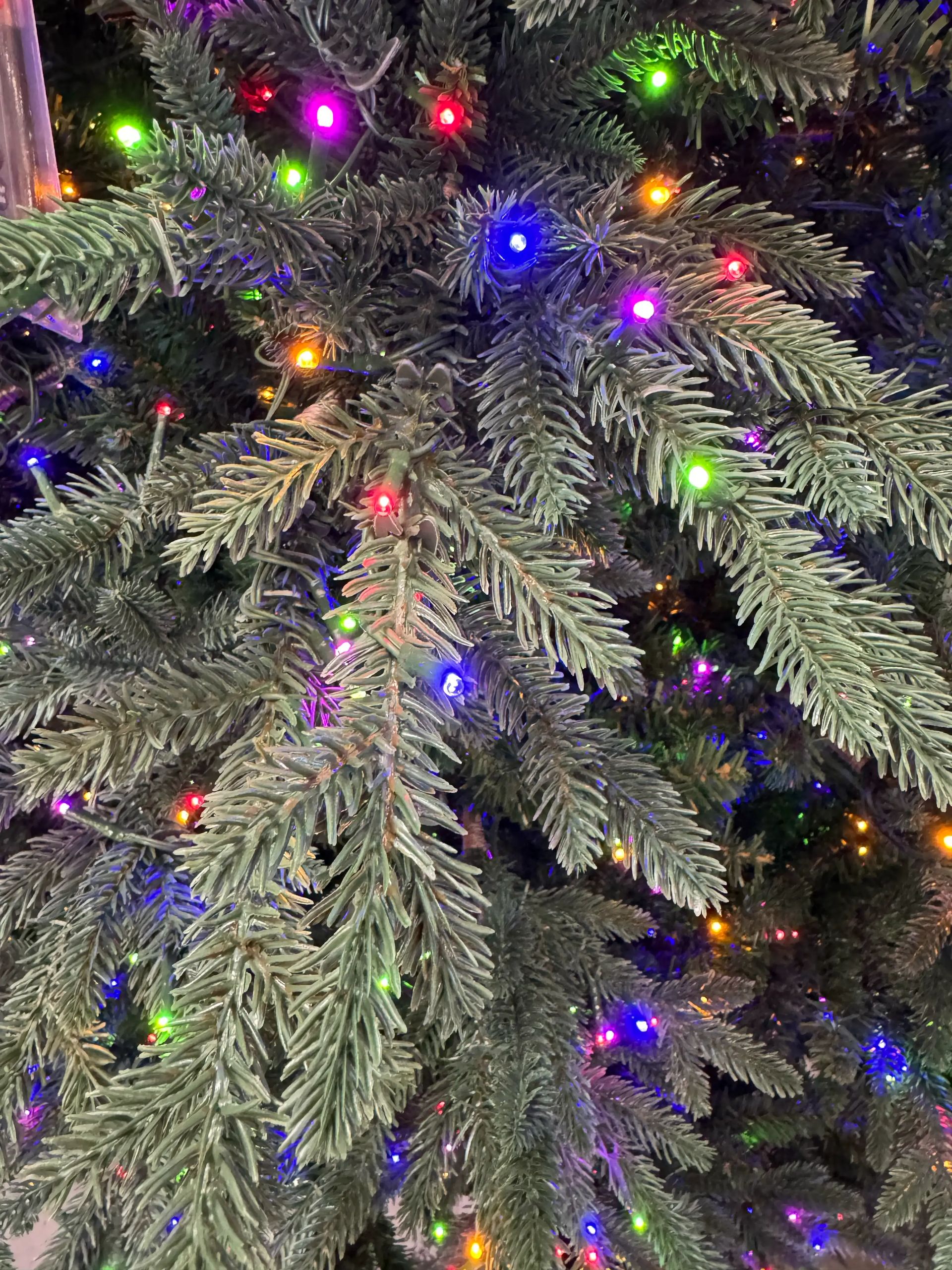 Dense mixed PVC/PE fir needles with multicolor LED lights, full coverage with minimal gaps, realistic texture
