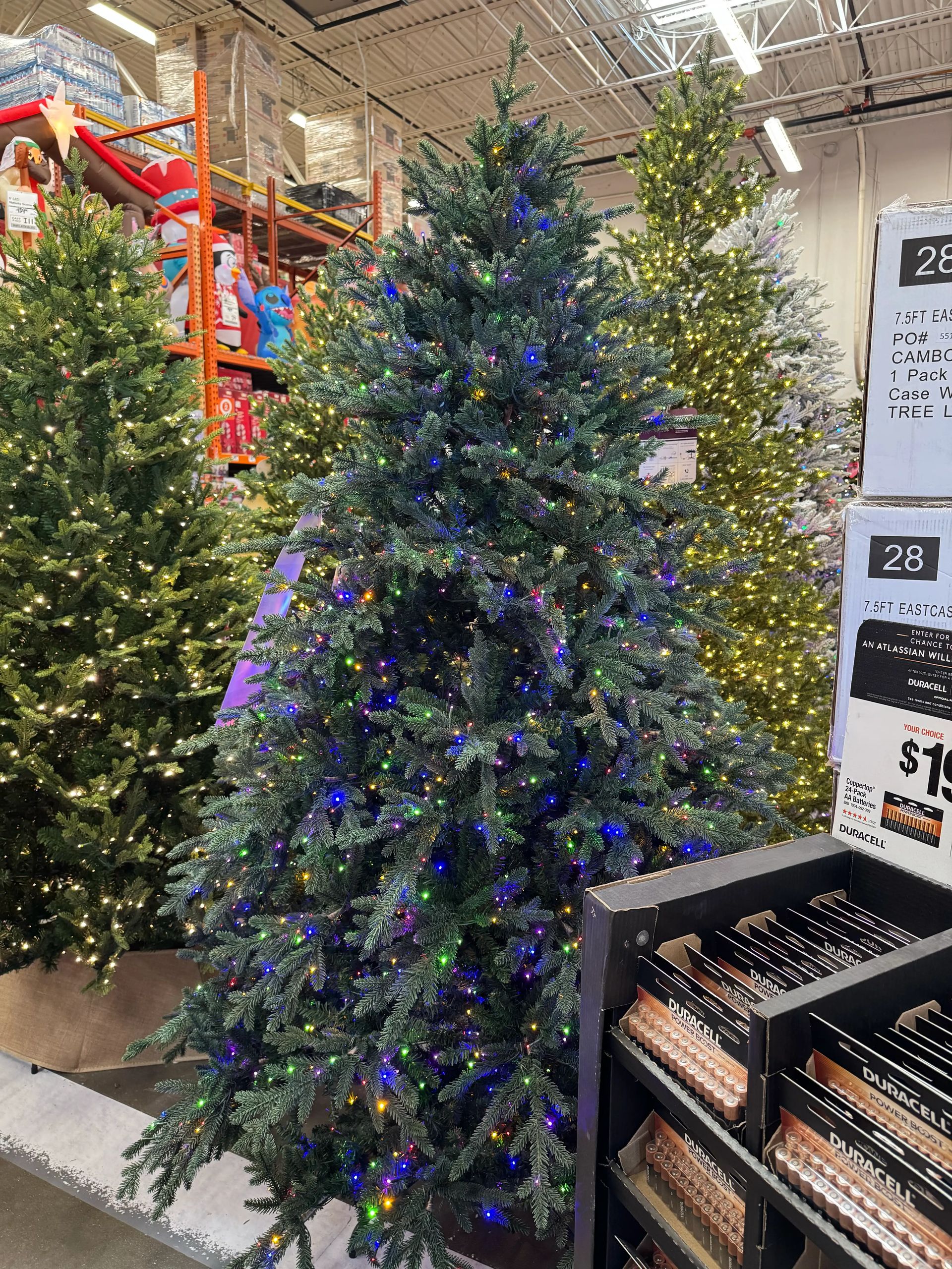 Dense mixed PVC/PE fir with full branching, multicolor LED lights (blue, purple, warm white), no visible gaps