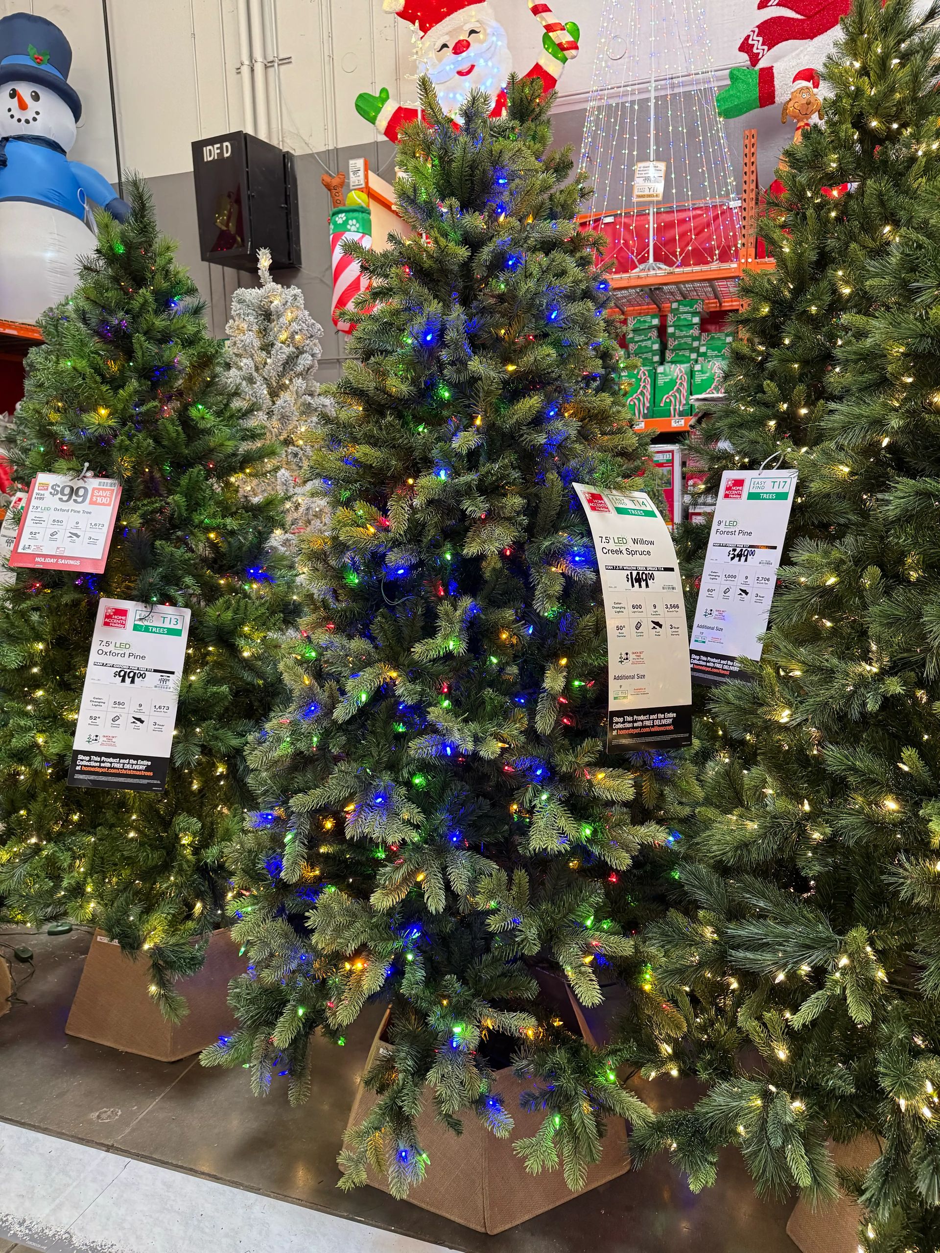 Mixed PVC/PE spruce with moderate branching, multicolor mini bulbs concentrated throughout, slight center gaps visible