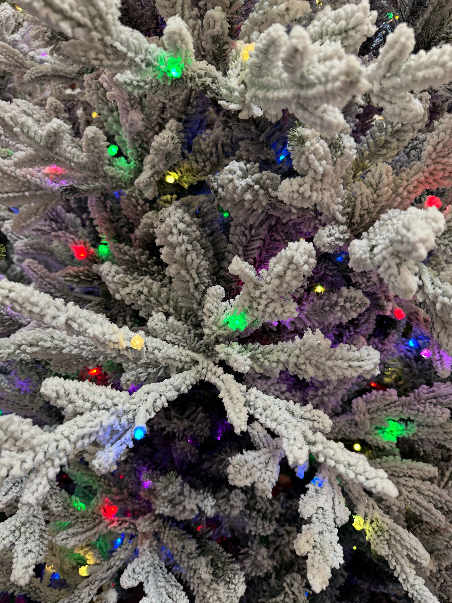 Dense flocked branches with heavy white coating, multicolor micro LEDs throughout, minimal gaps between branch layers
