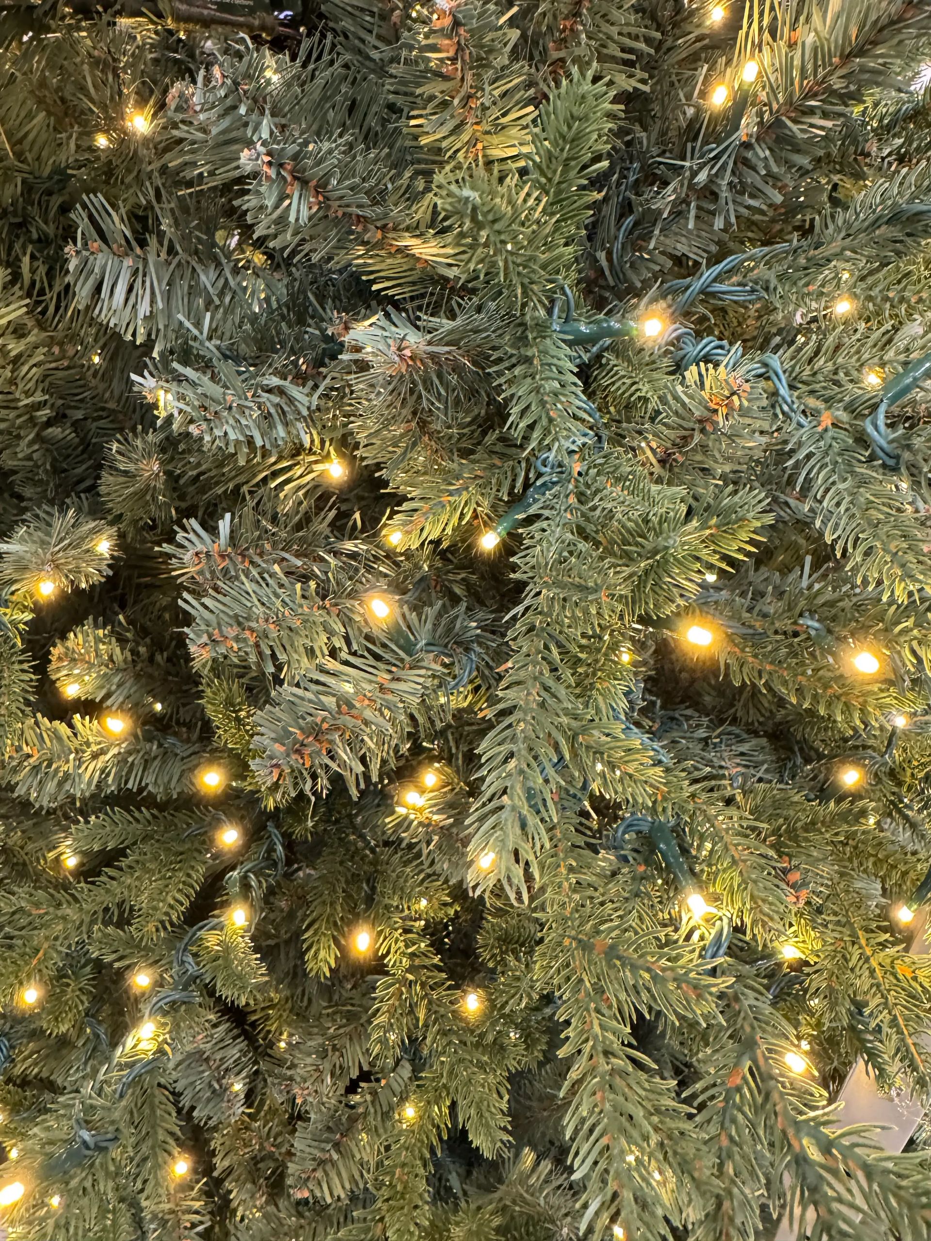Close-up of mixed PVC and PE fir needles in natural green, dense warm white LED coverage throughout branches