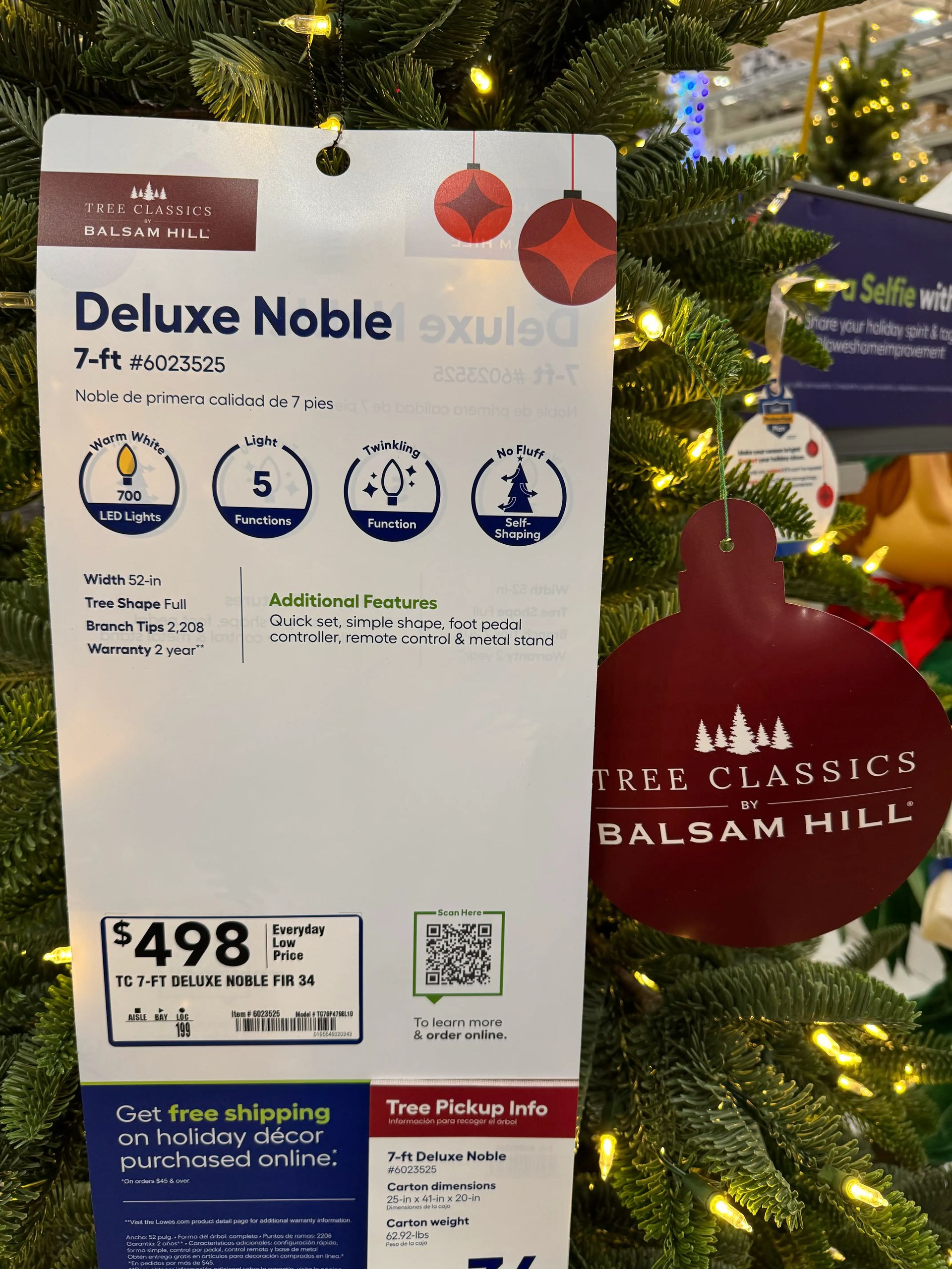 Product tag for 7-ft Noble fir: 700 warm white LEDs, 5 light functions, 52-in width, 2,208 tips, $498 price