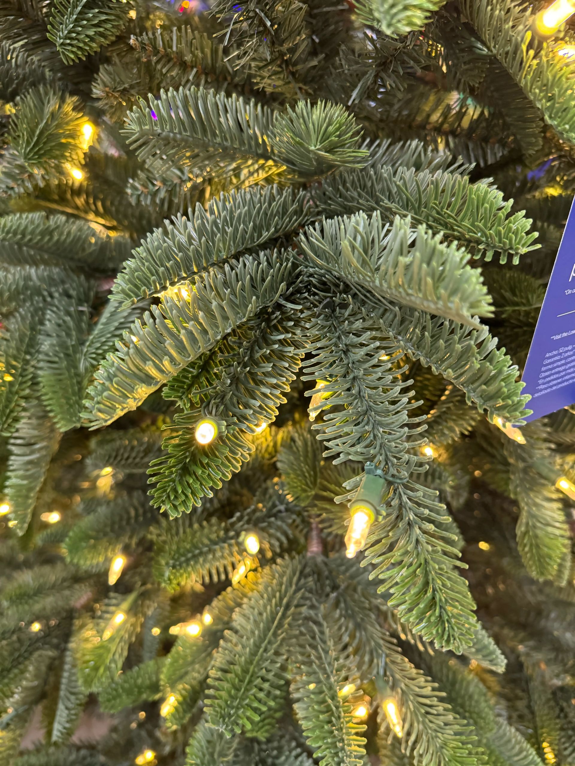 Dense mixed PVC/PE fir needles in blue-green tones, warm white micro LEDs throughout, minimal visible gaps