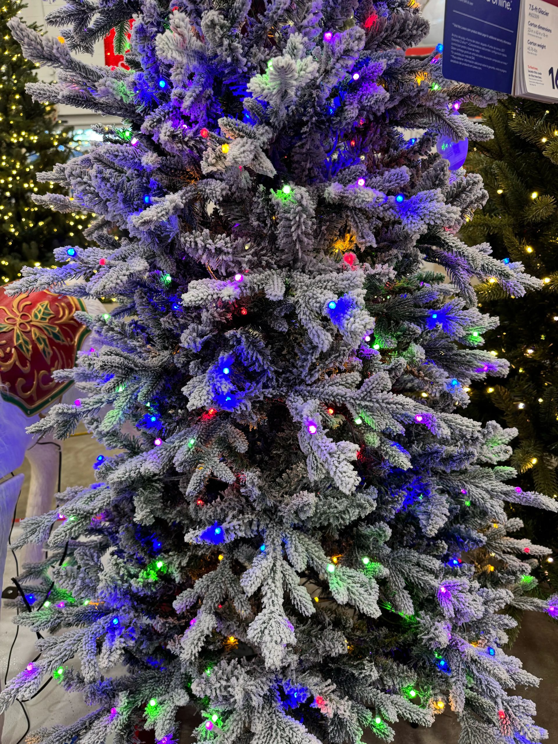 Flocked fir-style tree with heavy white coating, mixed PVC/PE needles, dense multicolor LED coverage throughout