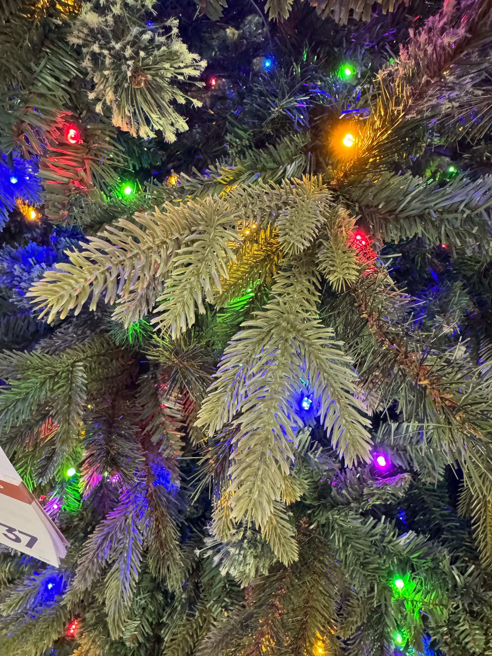 Mixed PVC pine branches with multicolor LED lights, moderate density, visible gaps between branch clusters
