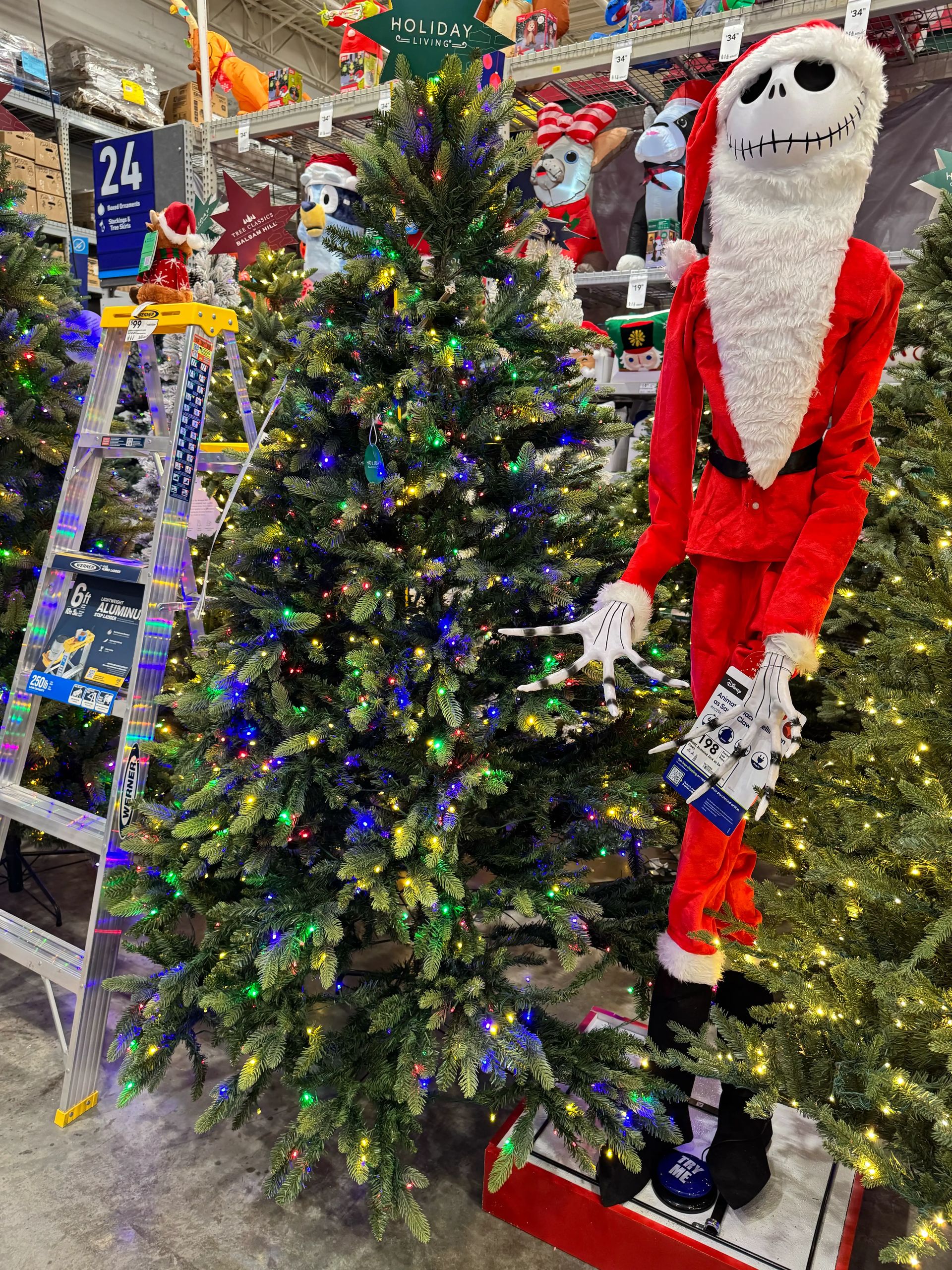 Traditional spruce with moderate PVC branching, some visible gaps, multicolor LED lights throughout, wide full shape