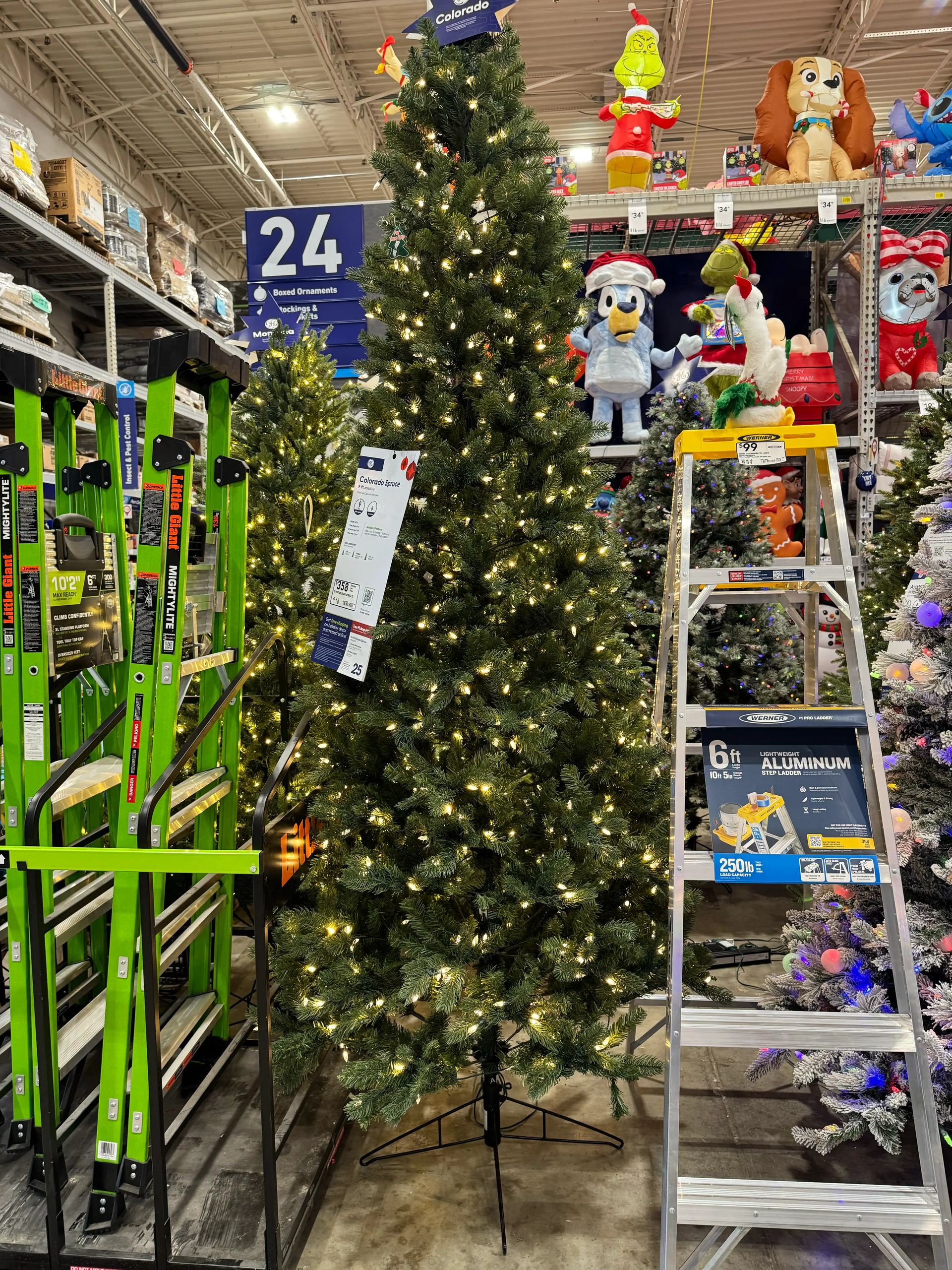 Mixed PVC/PE spruce with moderate branching and visible gaps, warm white mini LED bulbs evenly distributed throughout