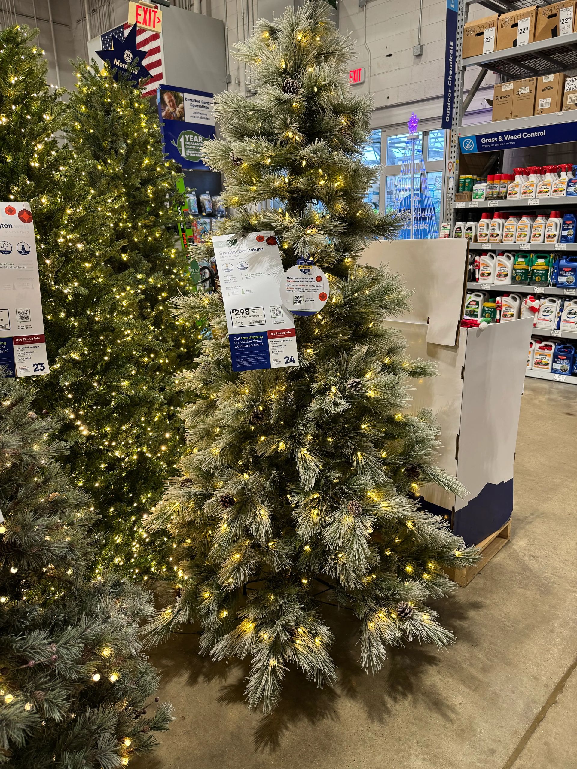 Frosted pine-style tree with white-tipped PVC needles, moderate branching with some gaps, warm white LED lights