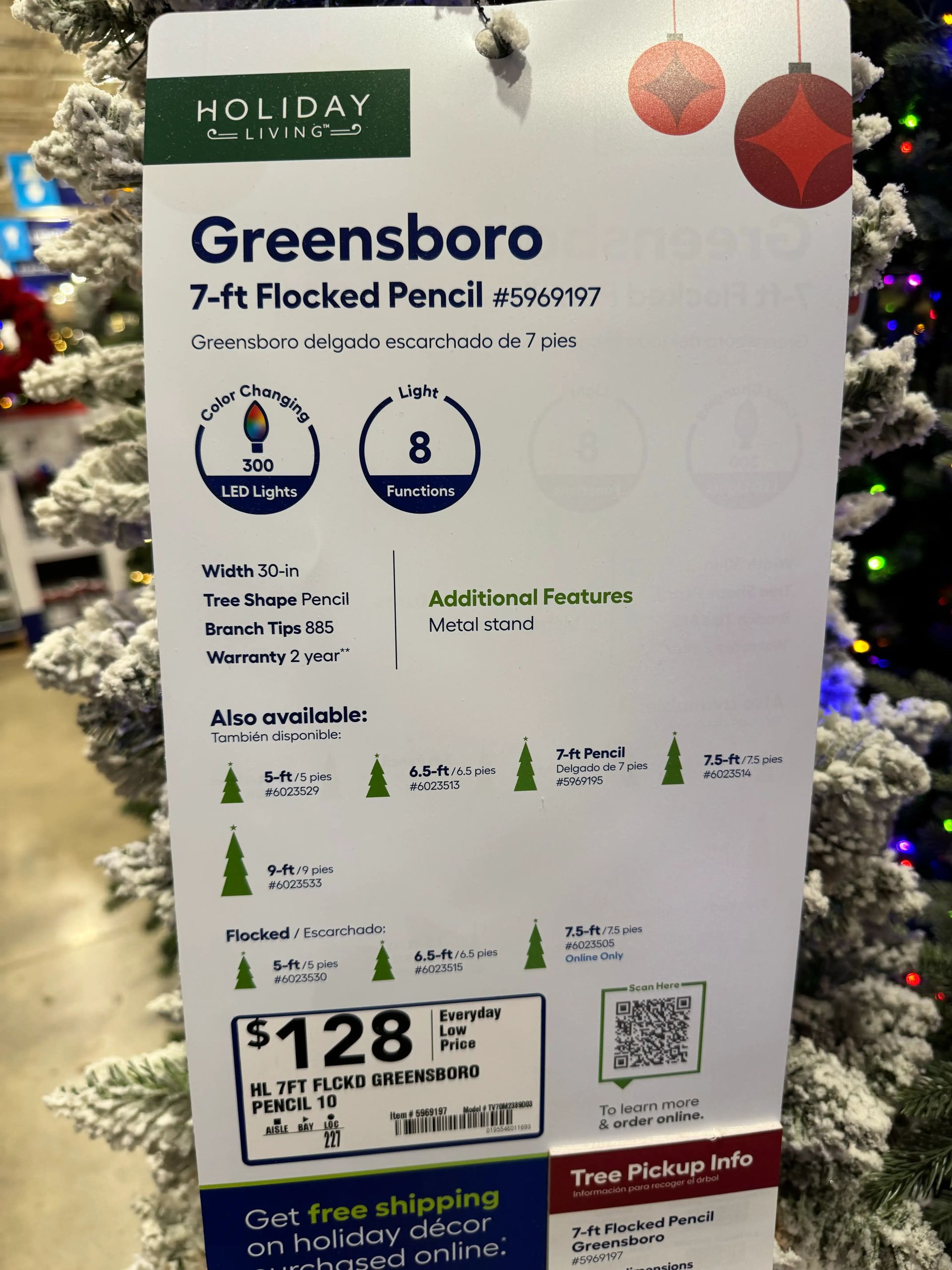 Product sign: 7ft flocked pencil tree, 30in width, 300 color-changing LEDs, 8 functions, 885 tips, $128