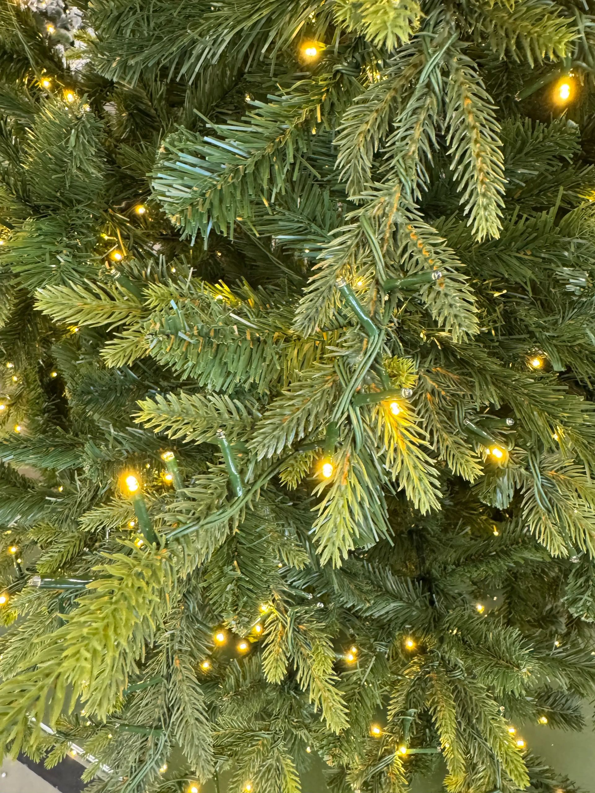 Mixed PVC and PE spruce needles in varied green tones, warm white micro LEDs evenly distributed, dense branch coverage